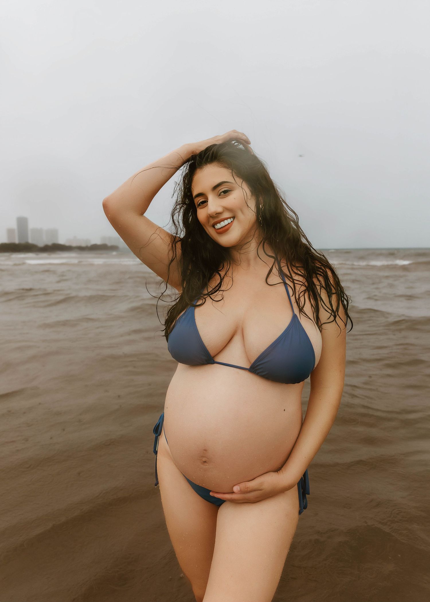 Beach Swim maternity session on overcast day on Montrose Beach in Chicago, IL