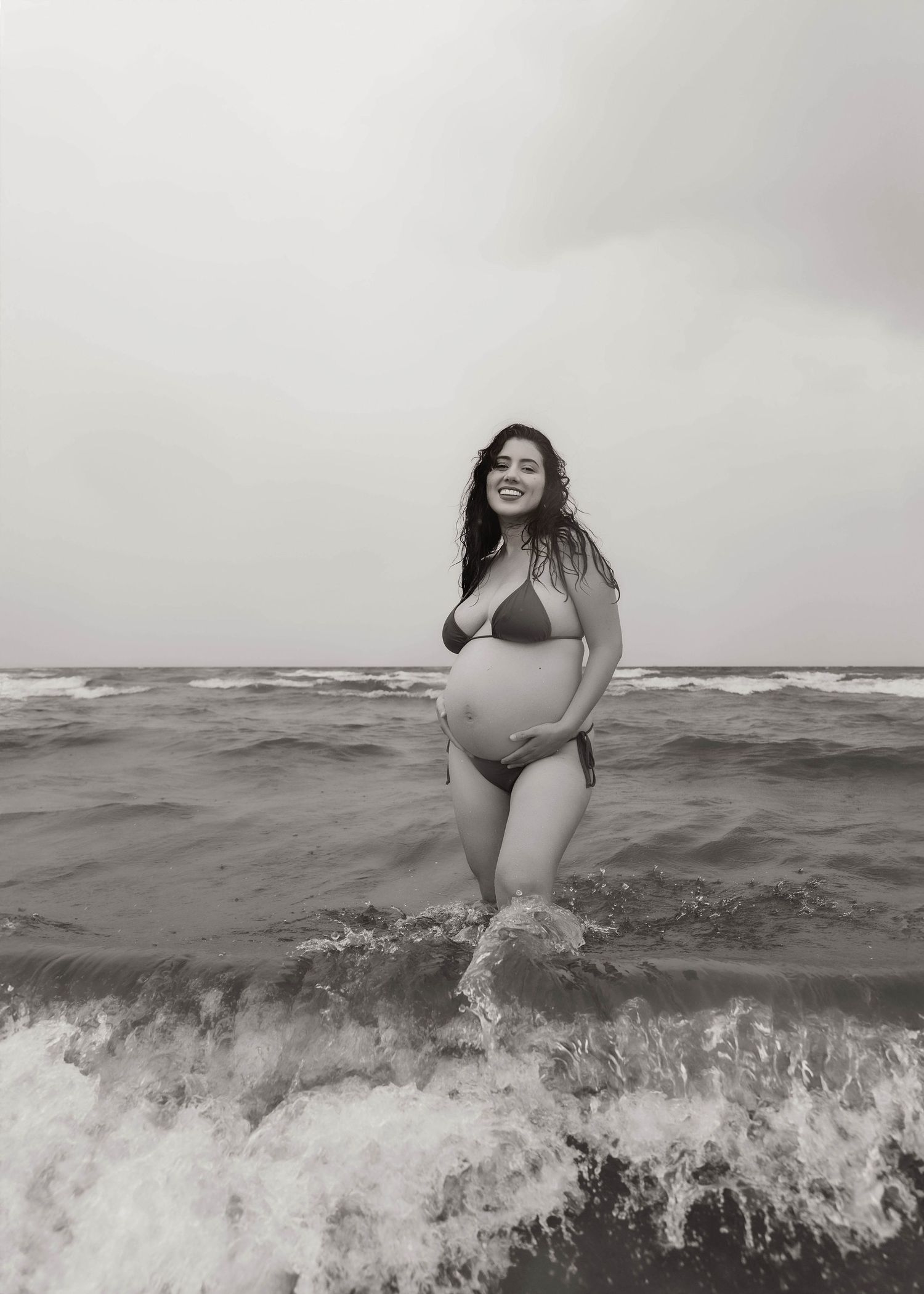 Beach Swim maternity session on overcast day on Montrose Beach in Chicago, IL