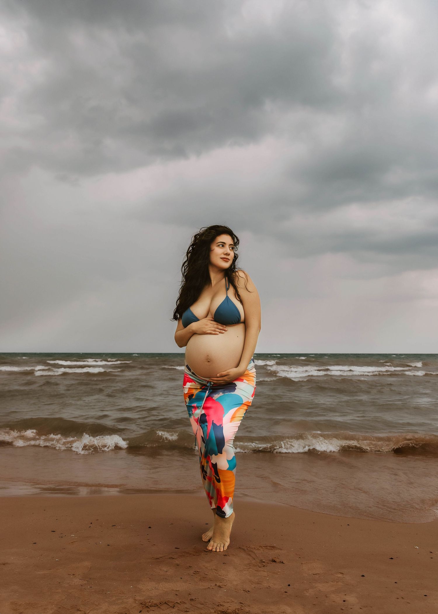 Beach Swim maternity session on overcast day on Montrose Beach in Chicago, IL