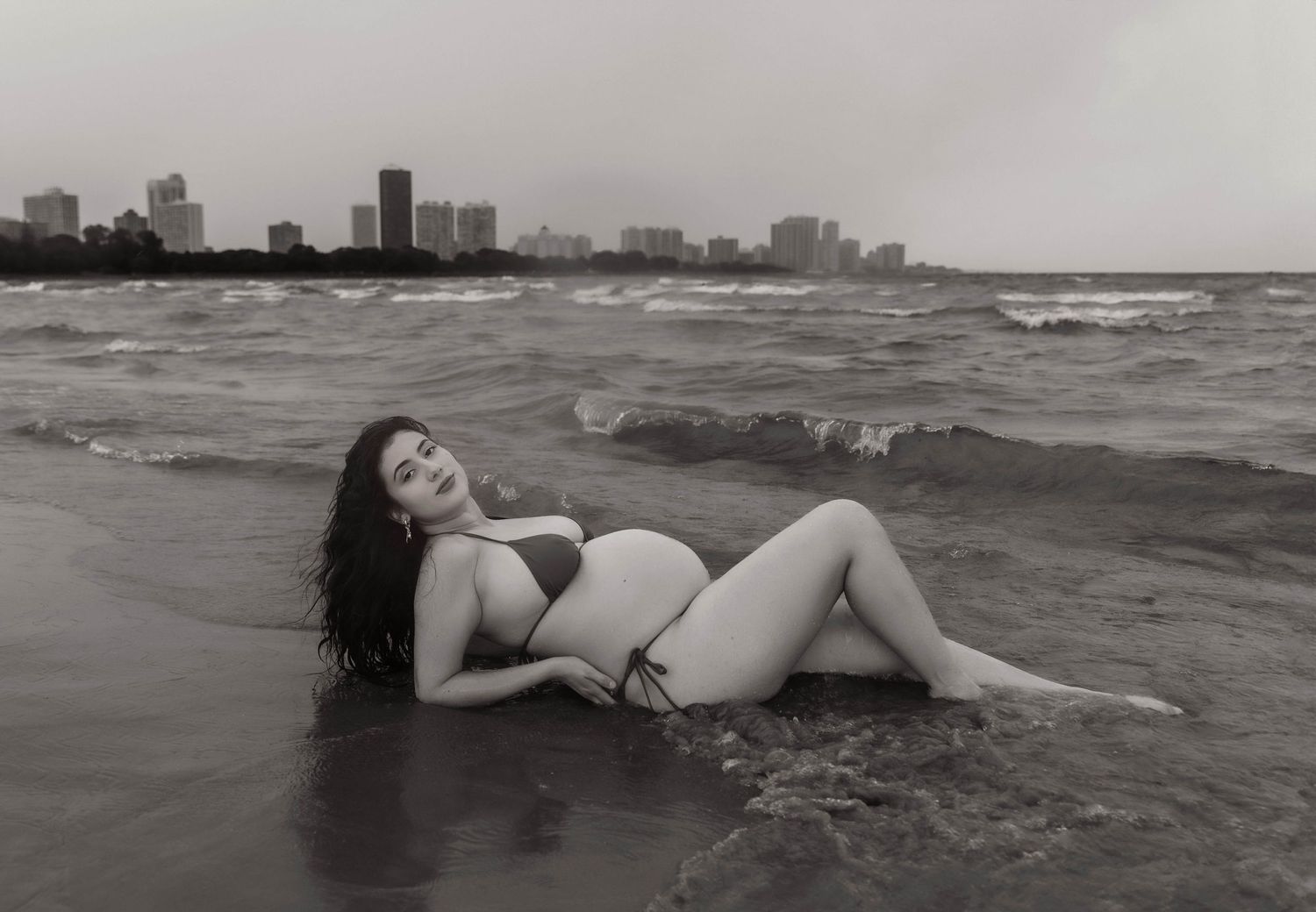 Beach Swim maternity session on overcast day on Montrose Beach in Chicago, IL