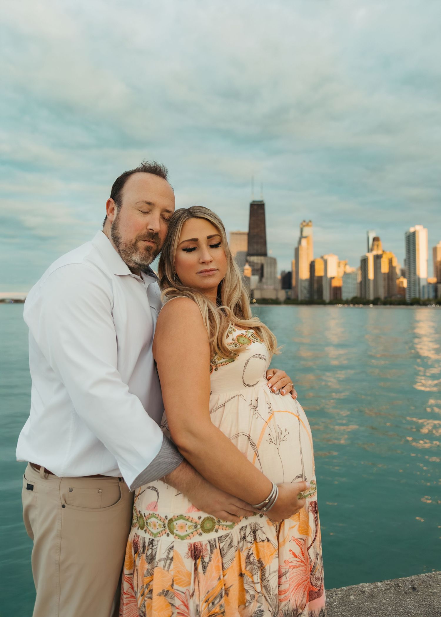 Couples maternity photography session with Chicago skyline at North Avenue Beach