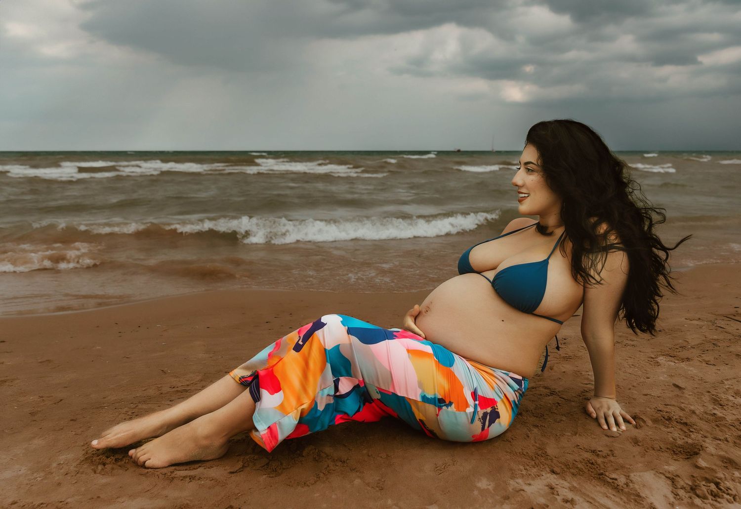 Beach Swim maternity session on overcast day on Montrose Beach in Chicago, IL