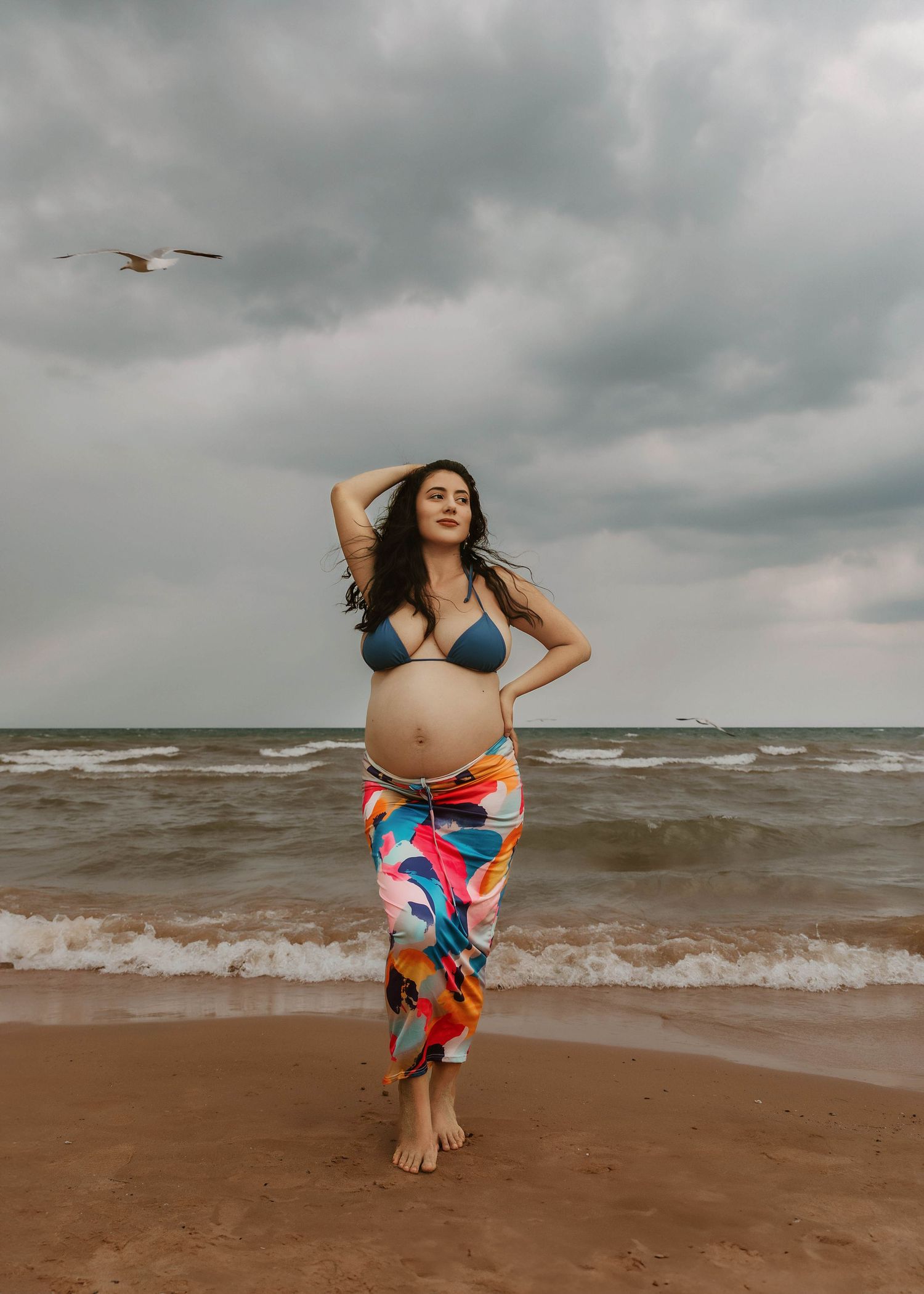 Beach Swim maternity session on overcast day on Montrose Beach in Chicago, IL