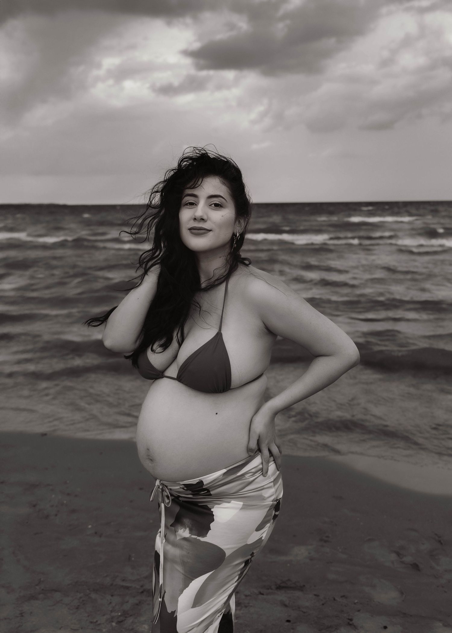 Beach Swim maternity session on overcast day on Montrose Beach in Chicago, IL