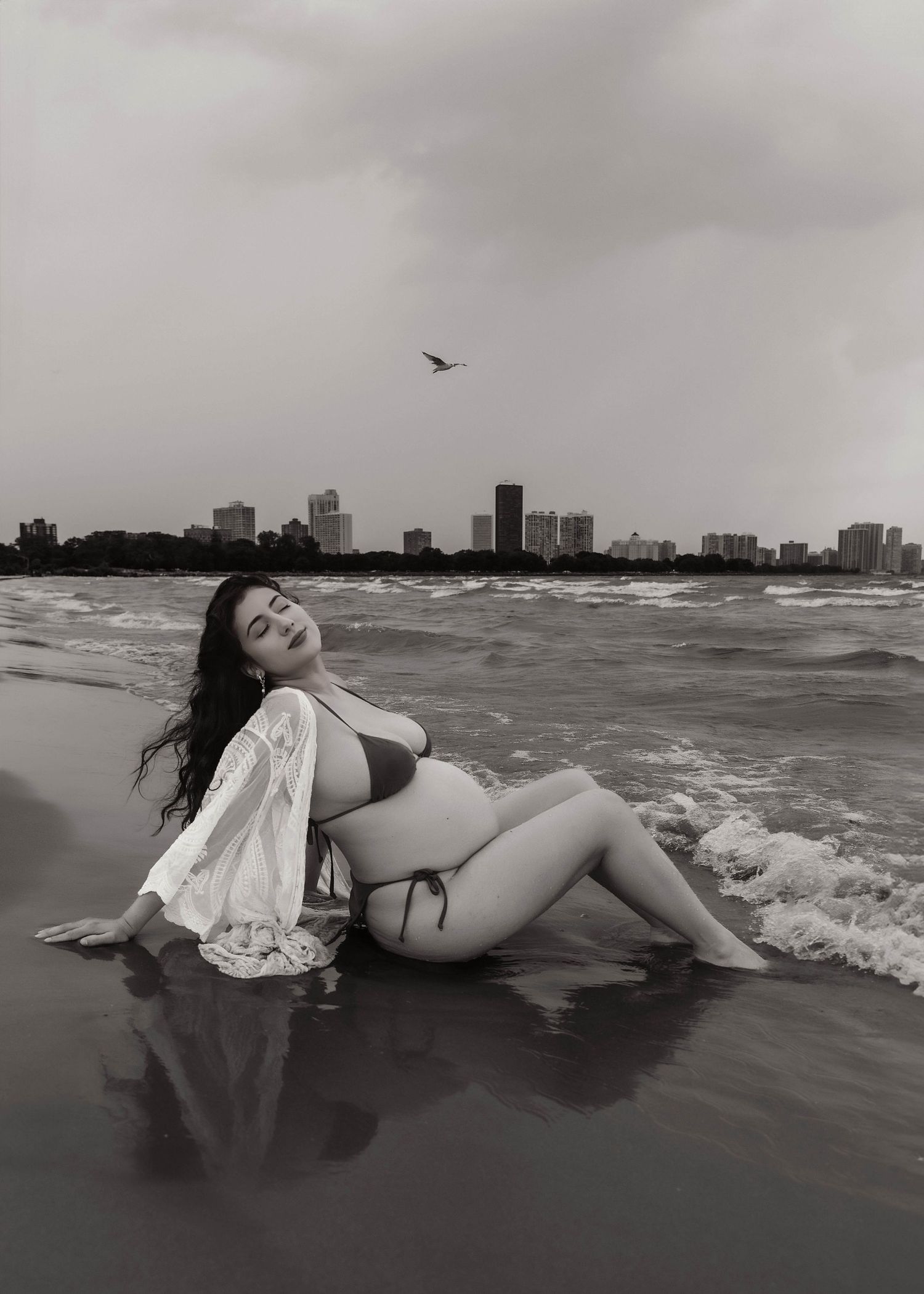 Beach Swim maternity session on overcast day on Montrose Beach in Chicago, IL