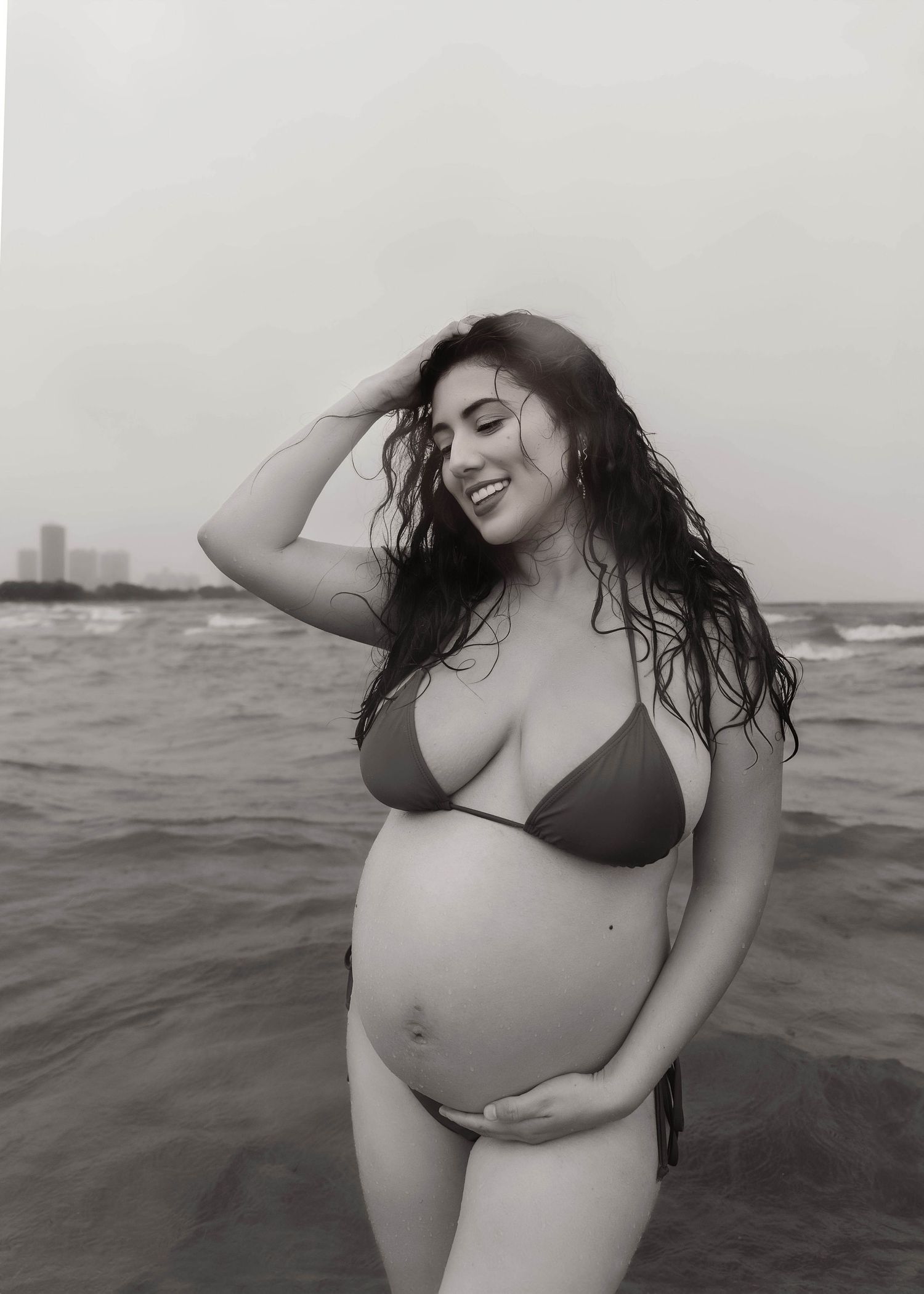 Beach Swim maternity session on overcast day on Montrose Beach in Chicago, IL