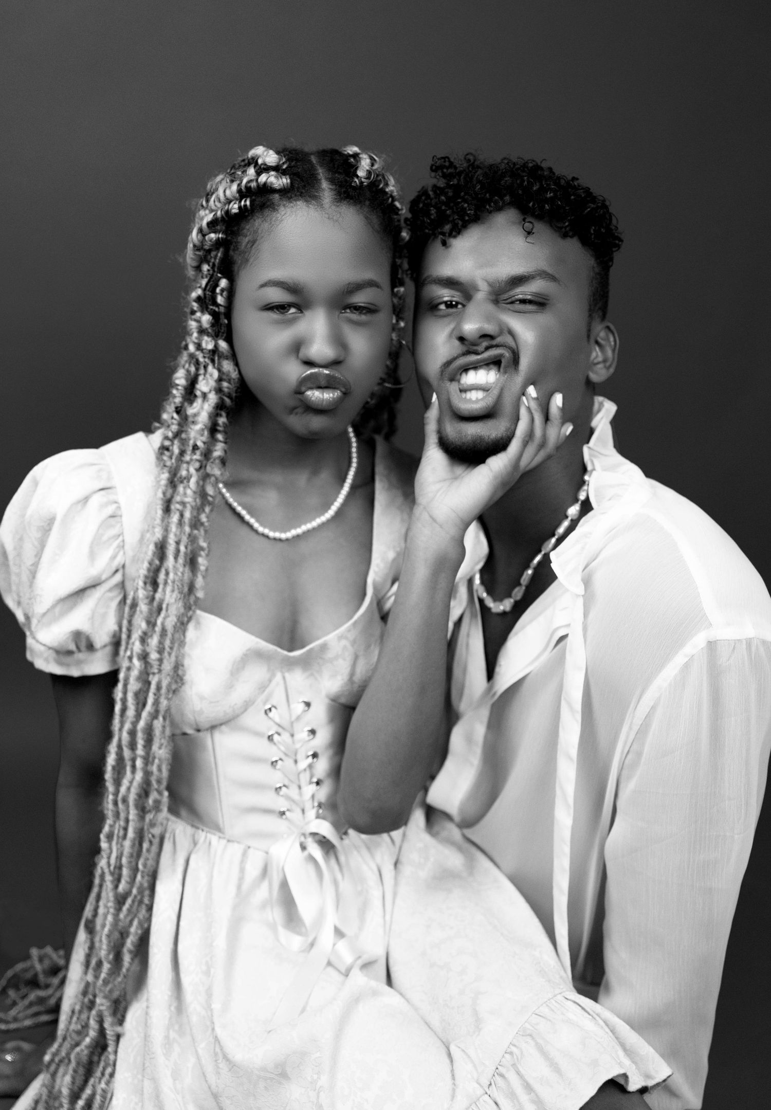 Couples in-studio playful portrait with young man and woman in black and white