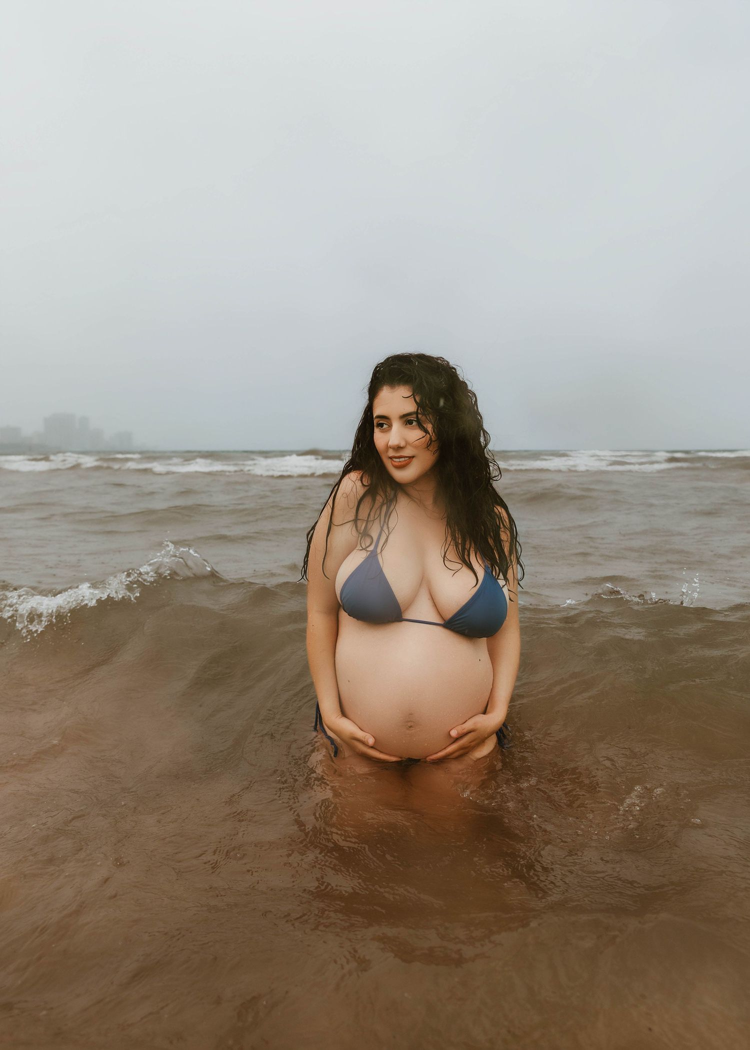 Beach Swim maternity session on overcast day on Montrose Beach in Chicago, IL