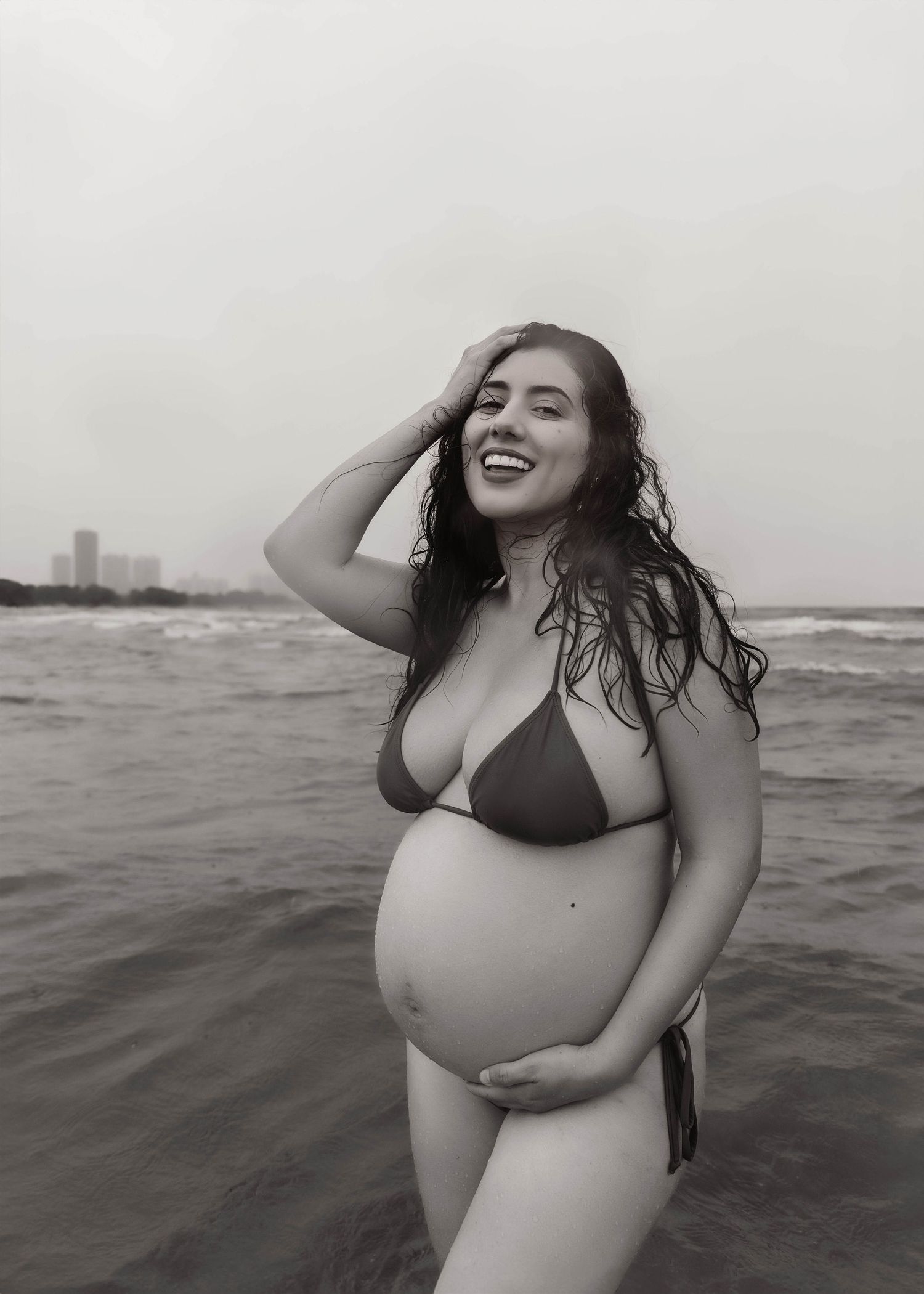 Beach Swim maternity session on overcast day on Montrose Beach in Chicago, IL