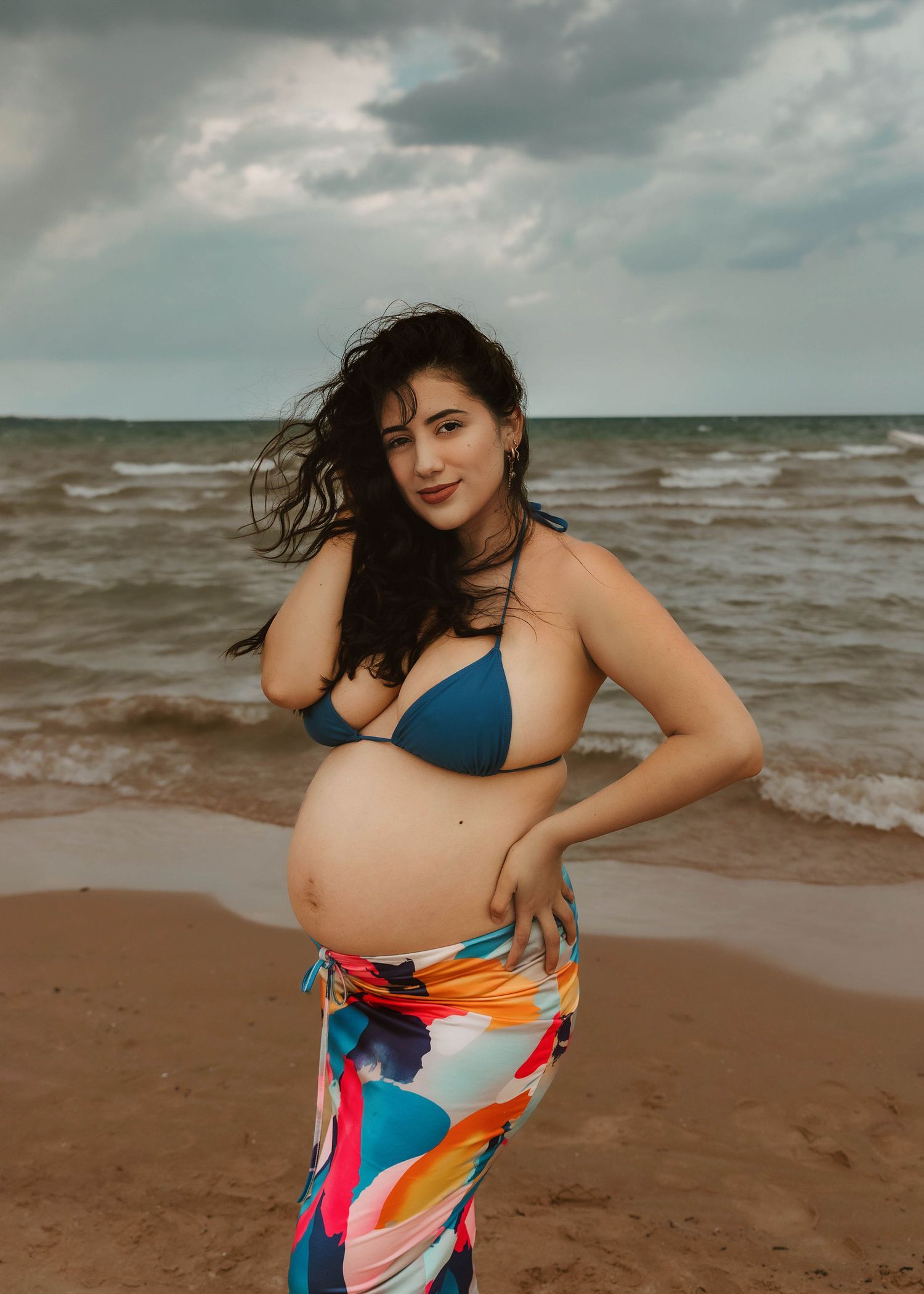 Beach Swim maternity session on overcast day on Montrose Beach in Chicago, IL
