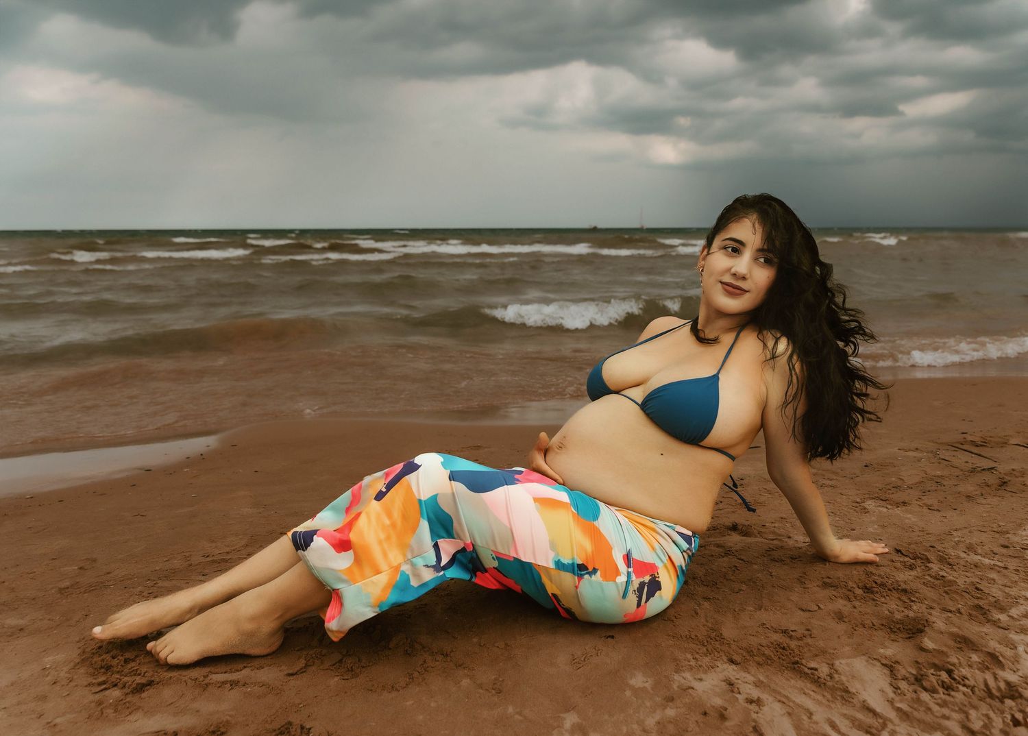 Beach Swim maternity session on overcast day on Montrose Beach in Chicago, IL