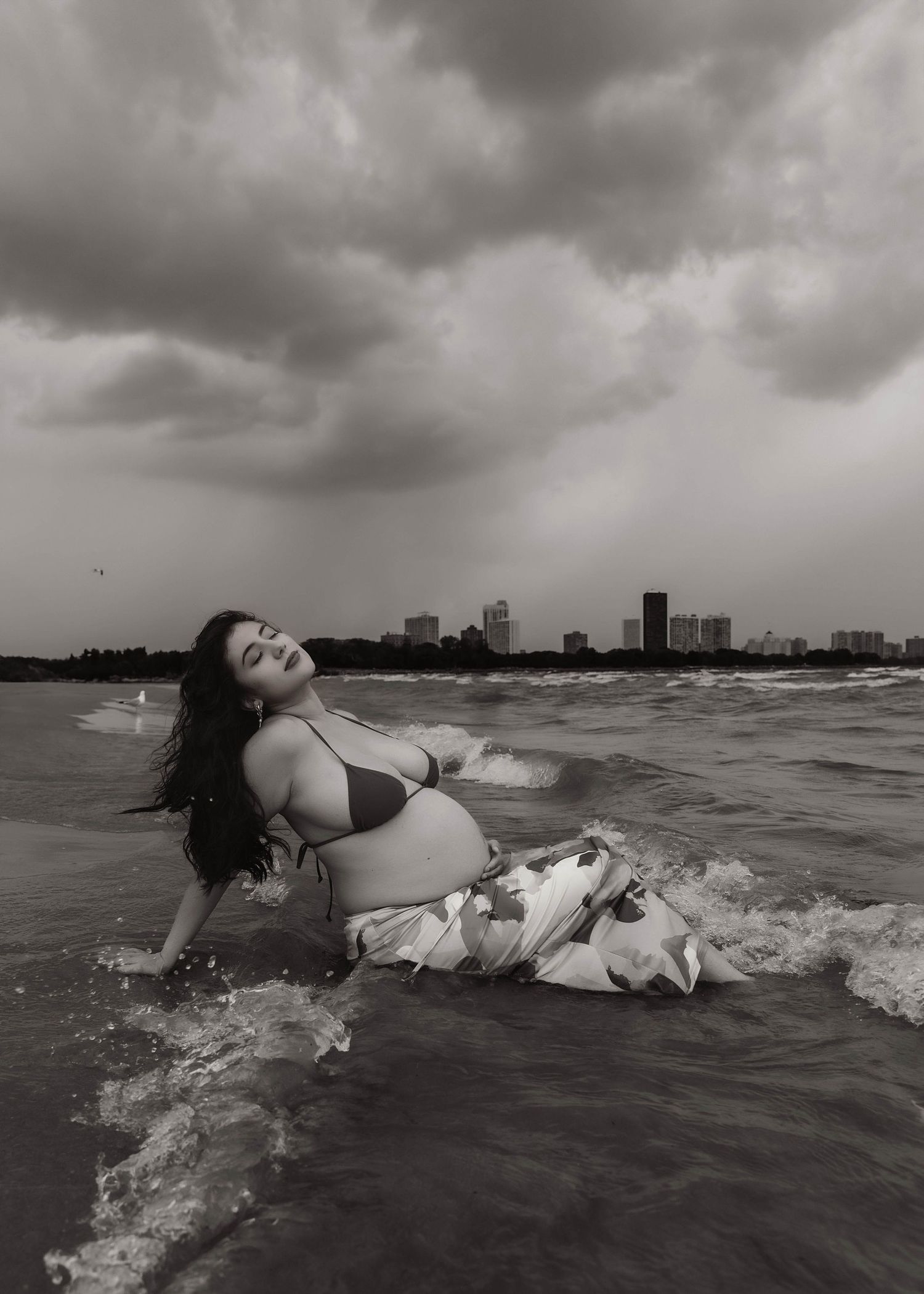 Beach Swim maternity session on overcast day on Montrose Beach in Chicago, IL