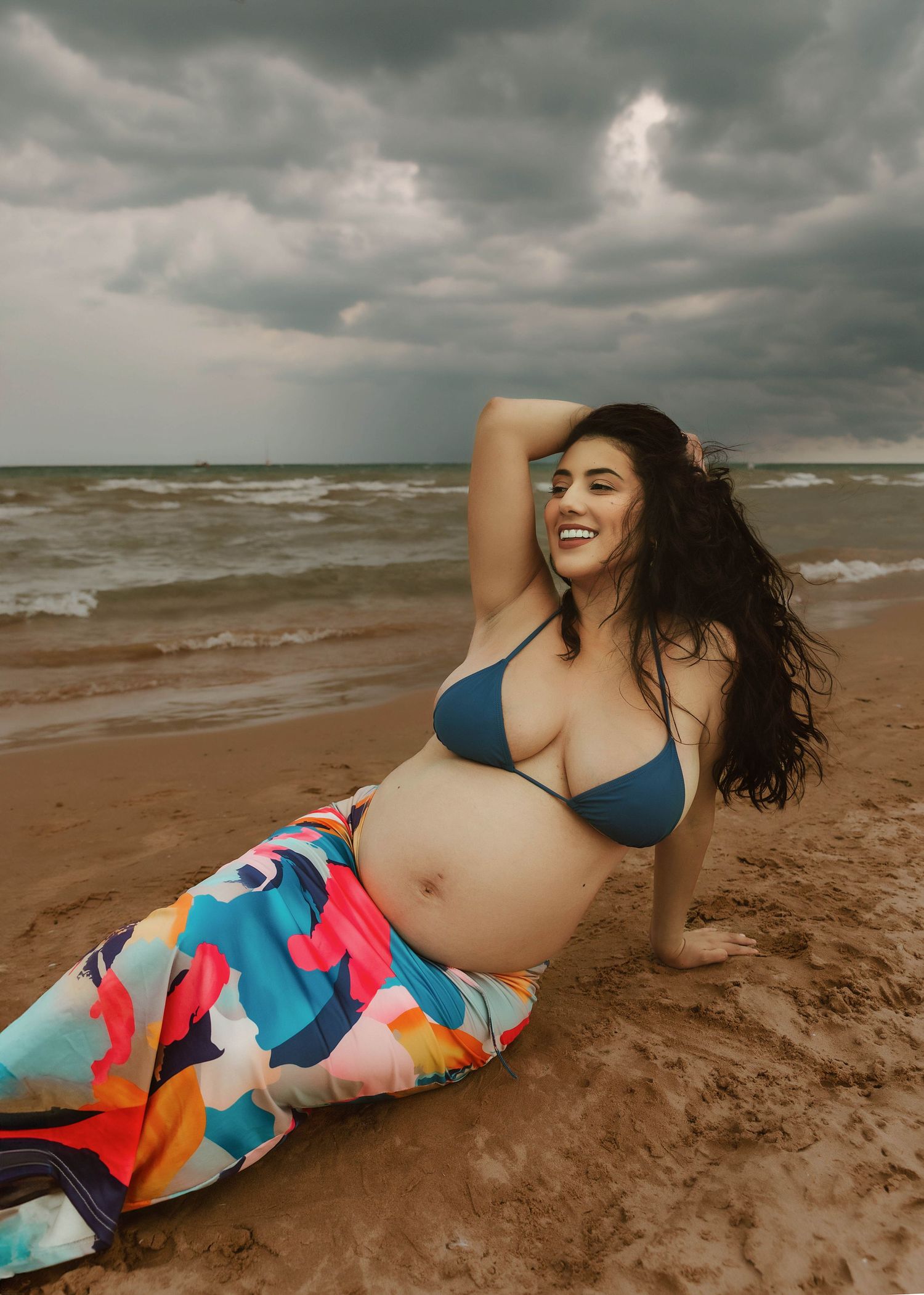 Beach Swim maternity session on overcast day on Montrose Beach in Chicago, IL