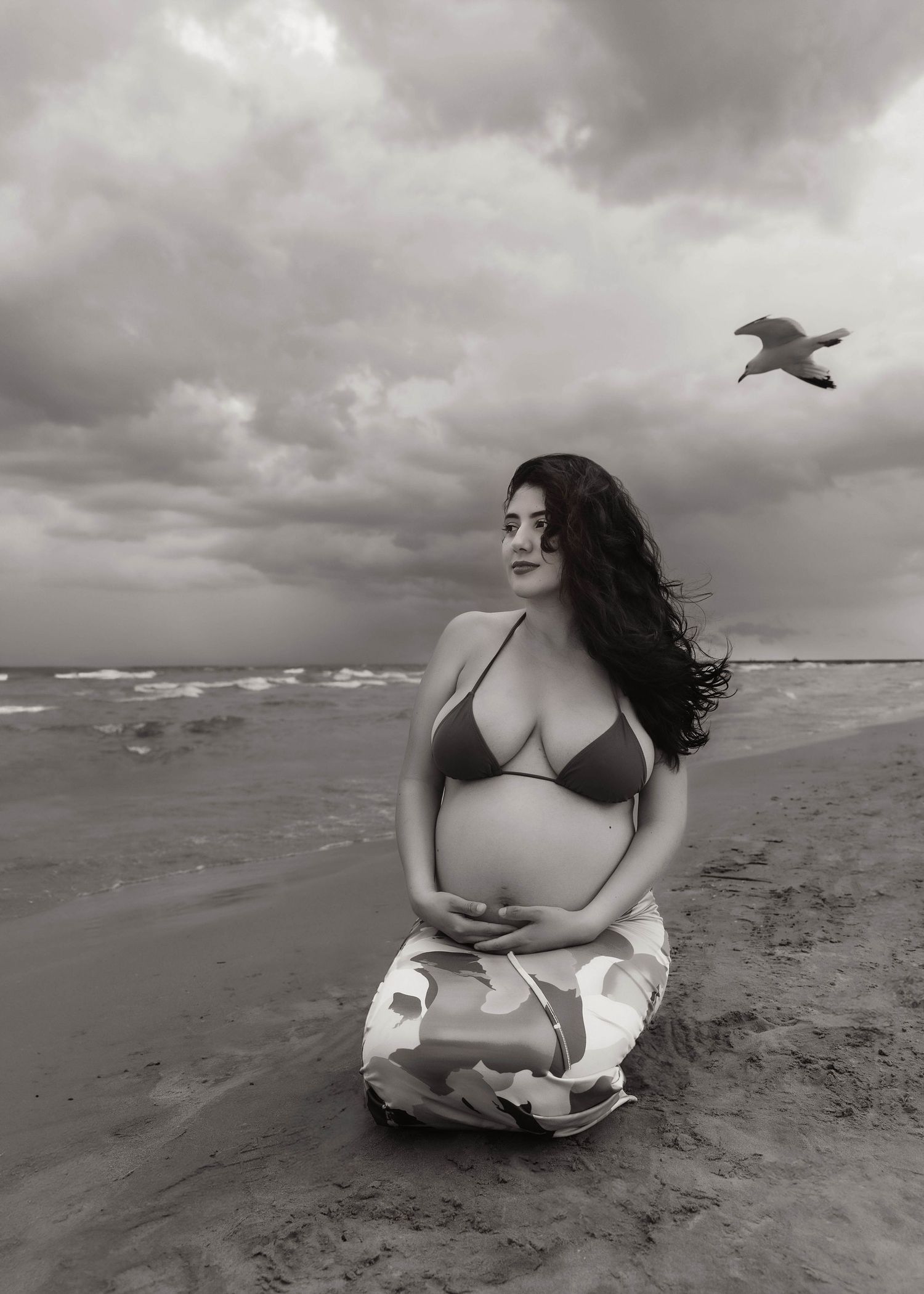 Beach Swim maternity session on overcast day on Montrose Beach in Chicago, IL