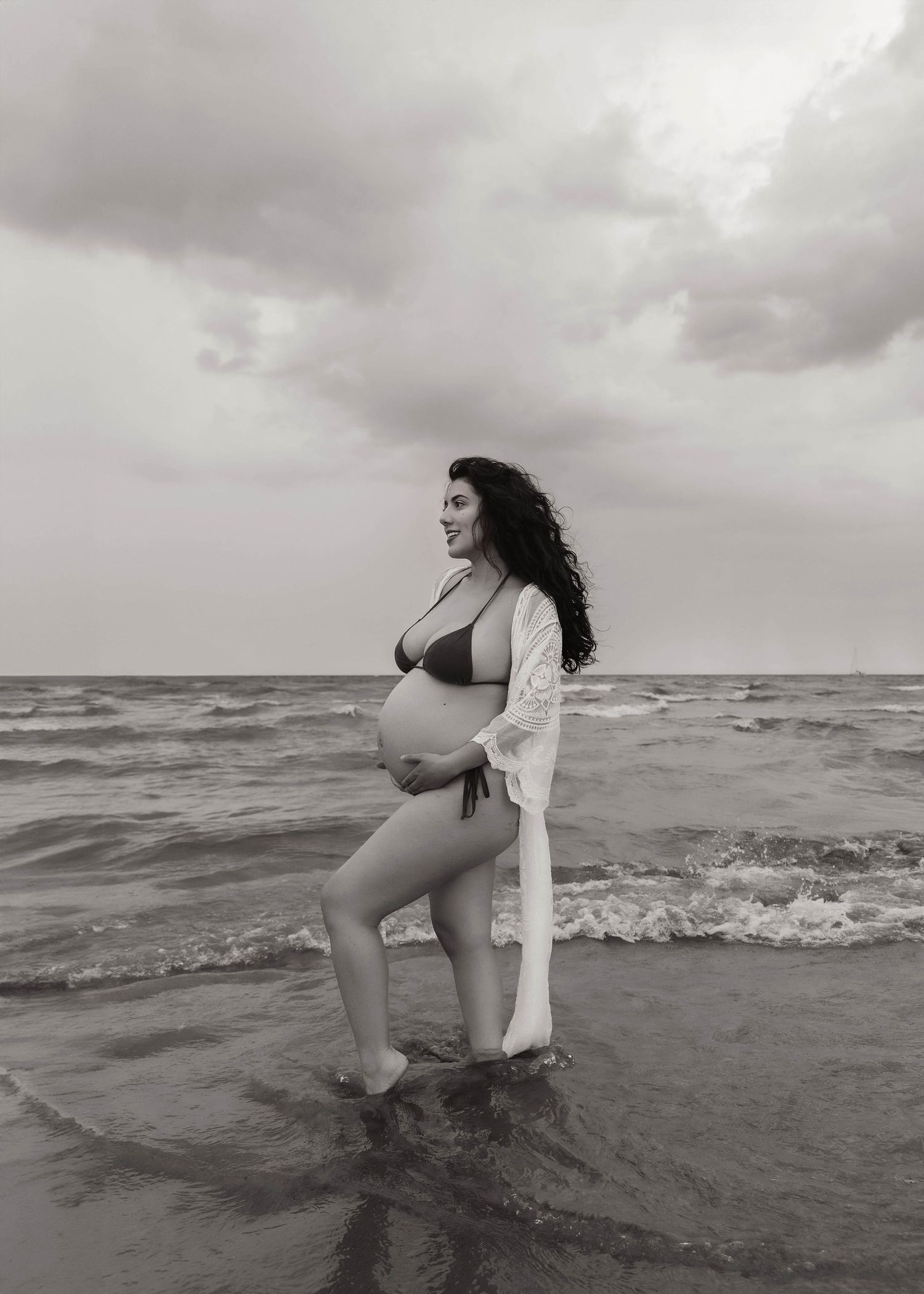 Beach Swim maternity session on overcast day on Montrose Beach in Chicago, IL