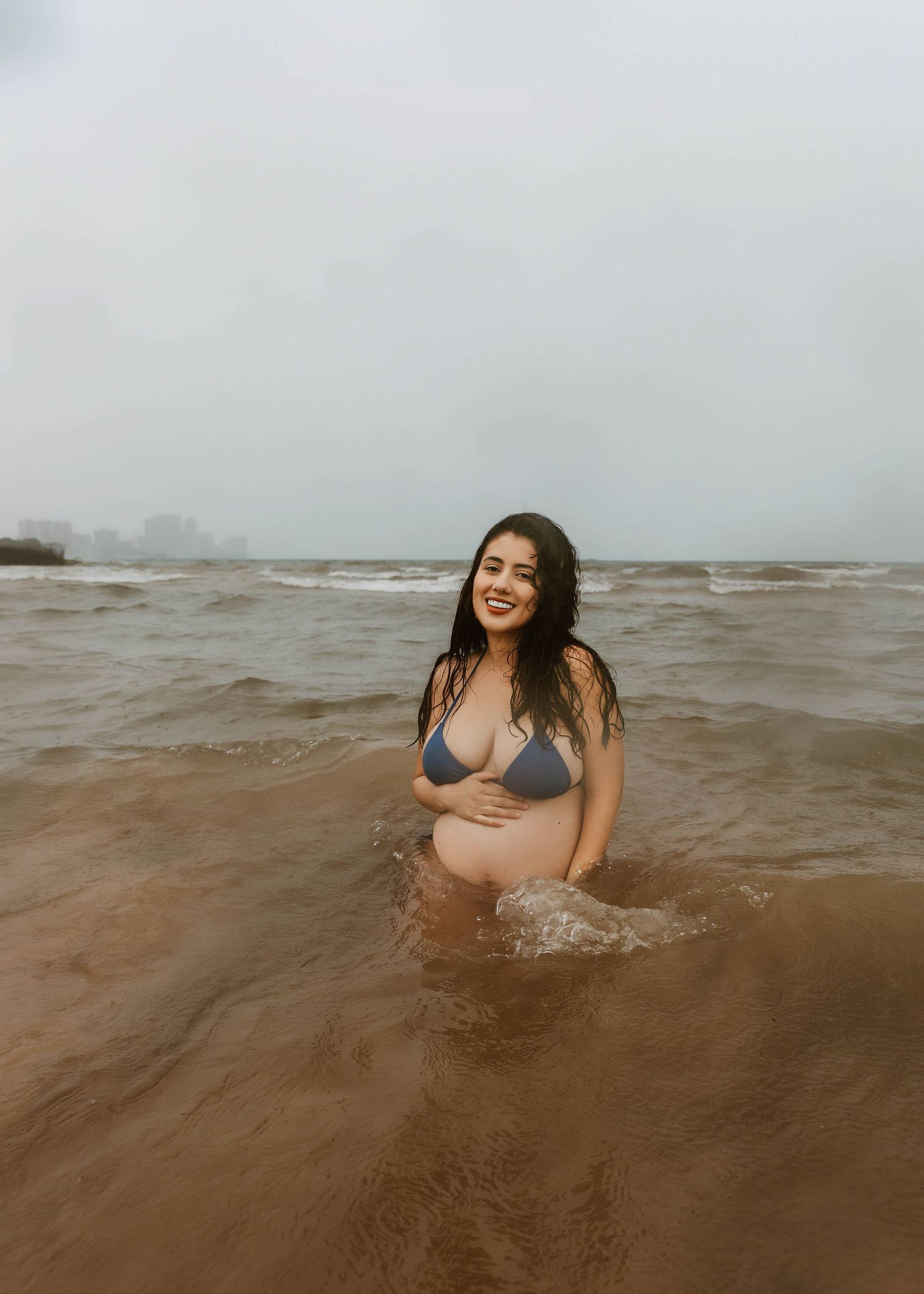Beach Swim maternity session on overcast day on Montrose Beach in Chicago, IL