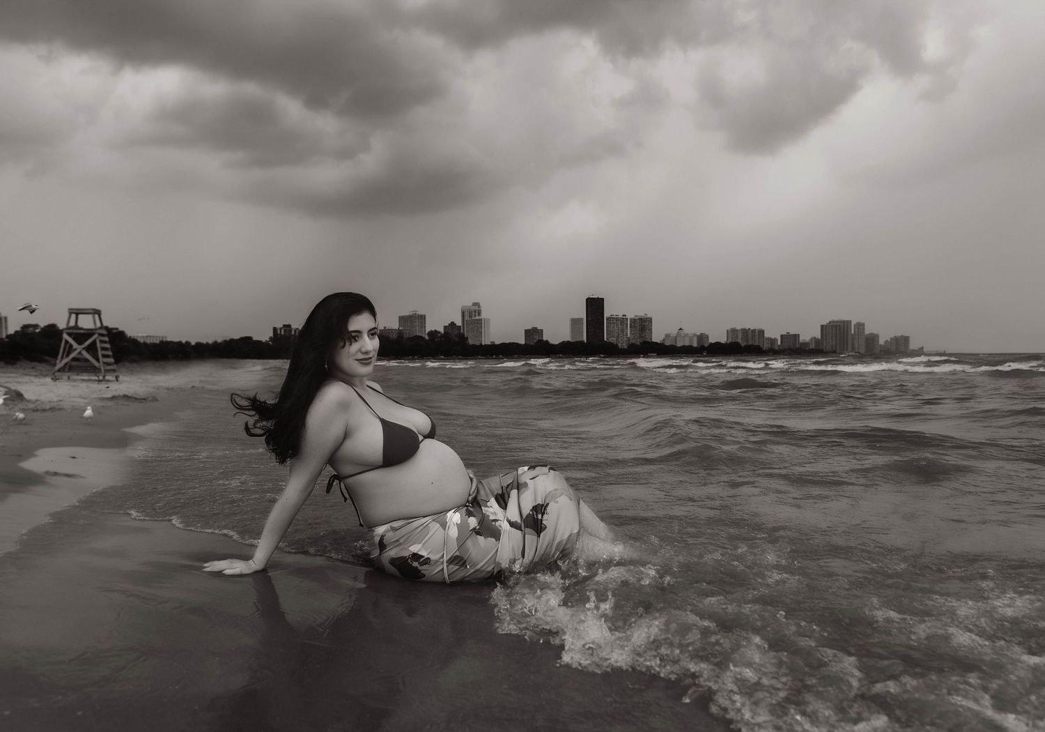 Beach Swim maternity session on overcast day on Montrose Beach in Chicago, IL