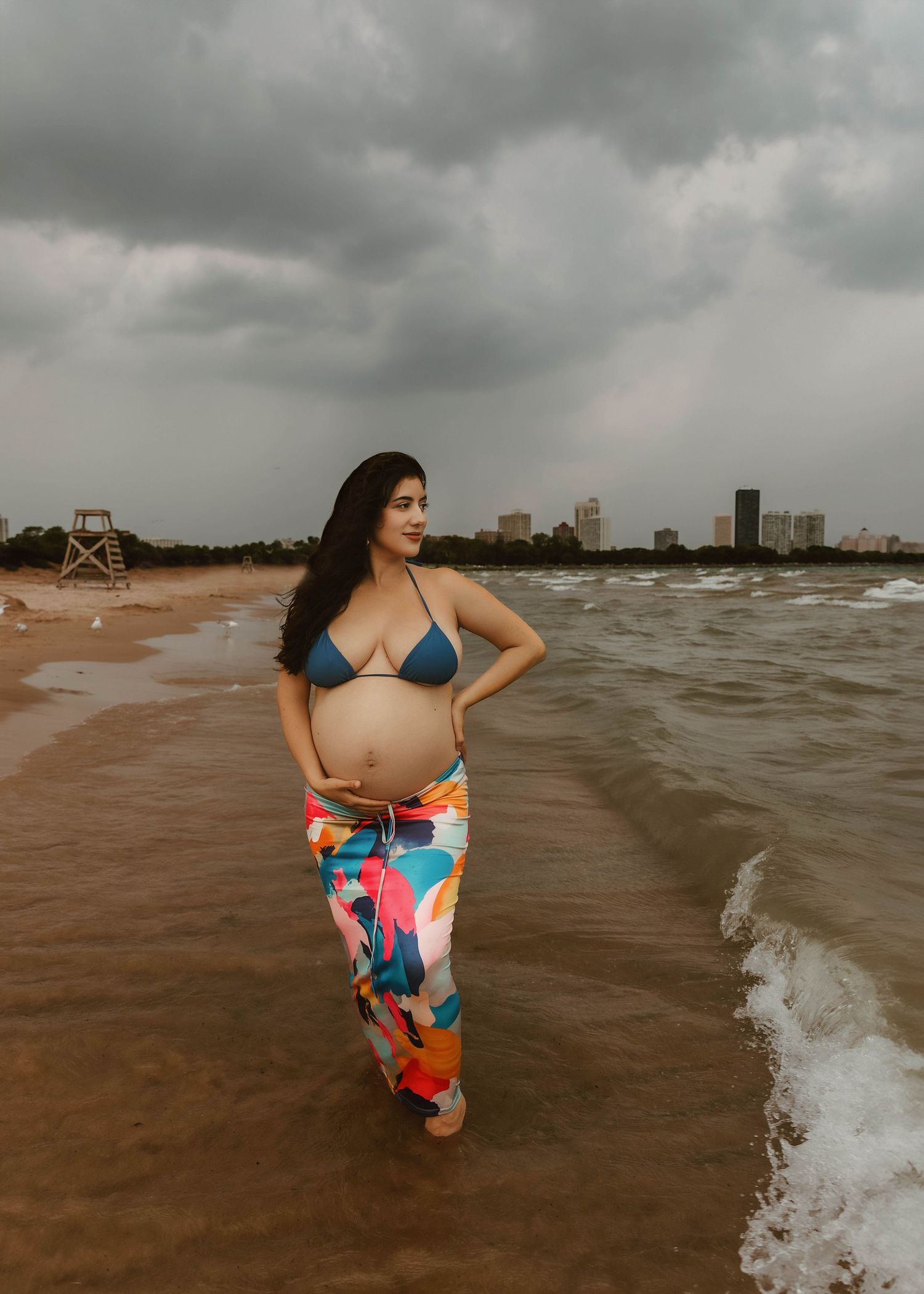 Beach Swim maternity session on overcast day on Montrose Beach in Chicago, IL