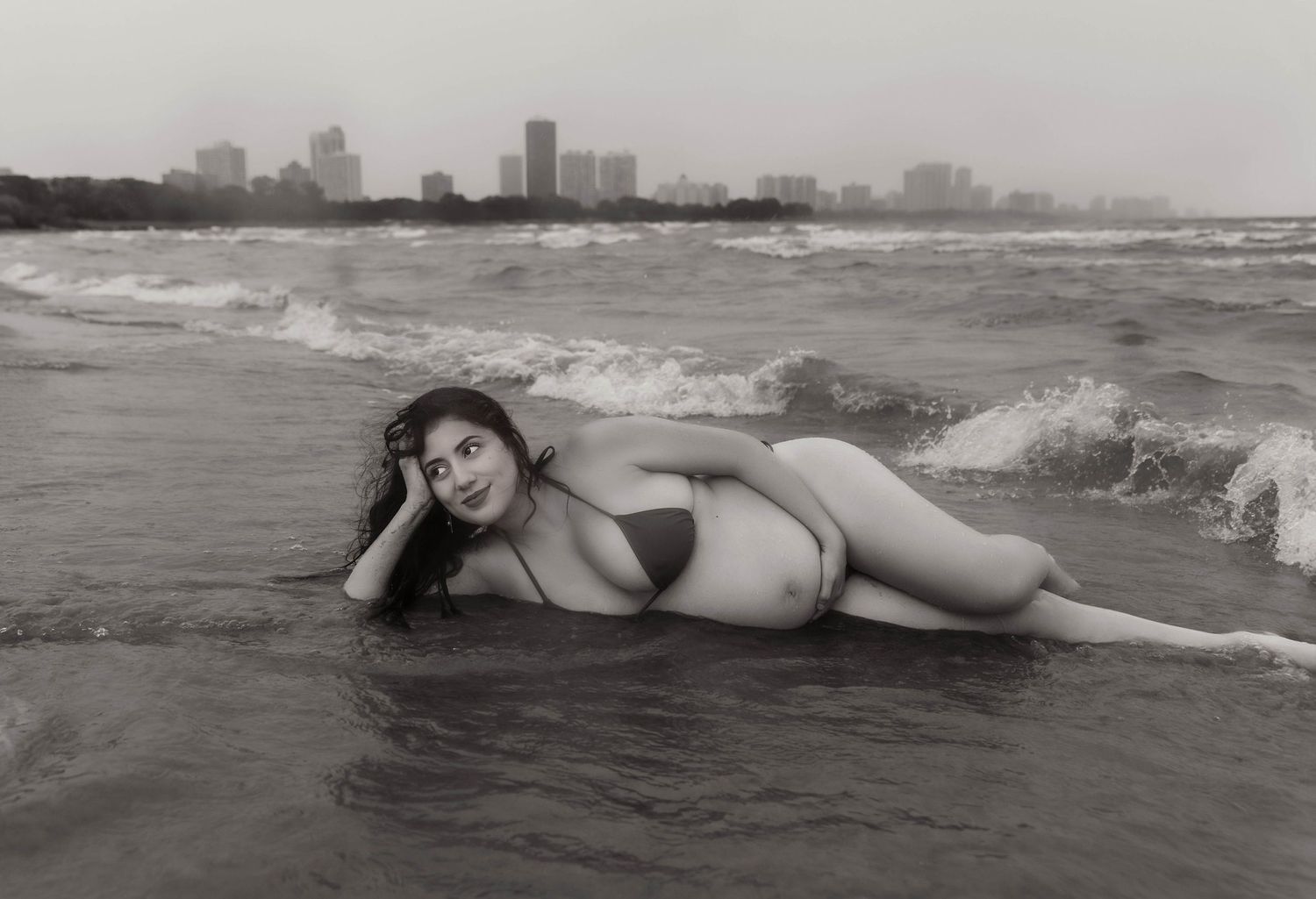 Beach Swim maternity session on overcast day on Montrose Beach in Chicago, IL