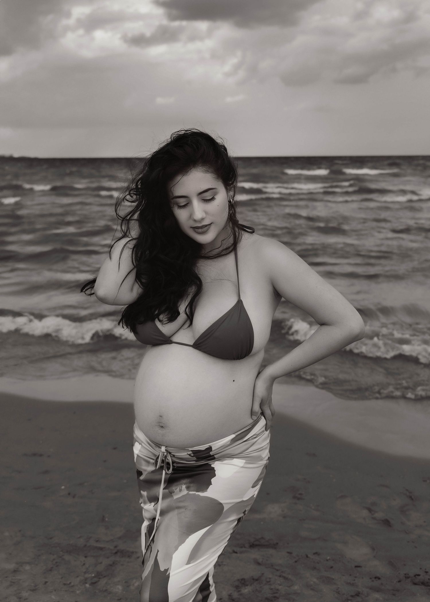 Beach Swim maternity session on overcast day on Montrose Beach in Chicago, IL