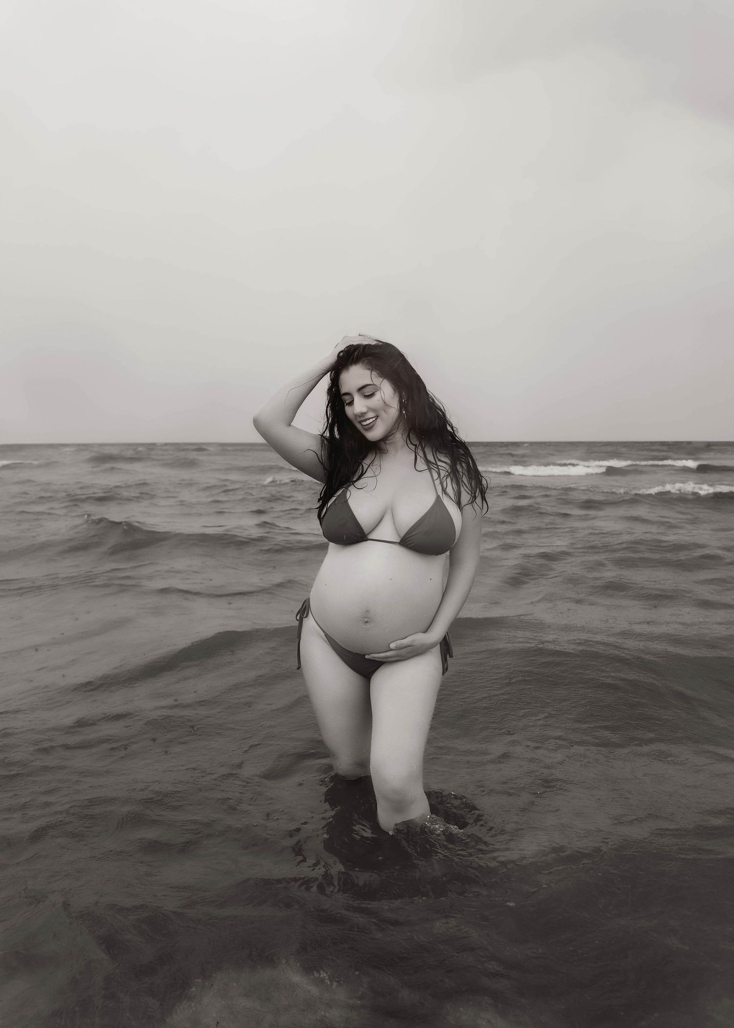 Beach Swim maternity session on overcast day on Montrose Beach in Chicago, IL