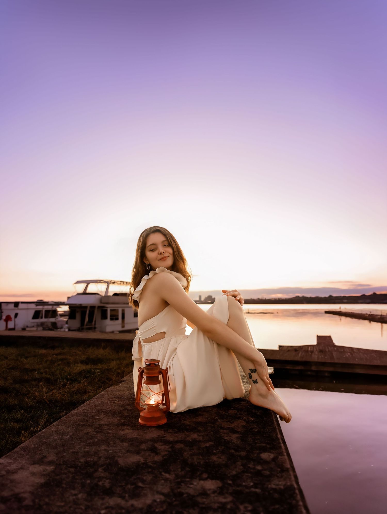 Purple sunset photo with lantern and white dress in East Peoria Illinois