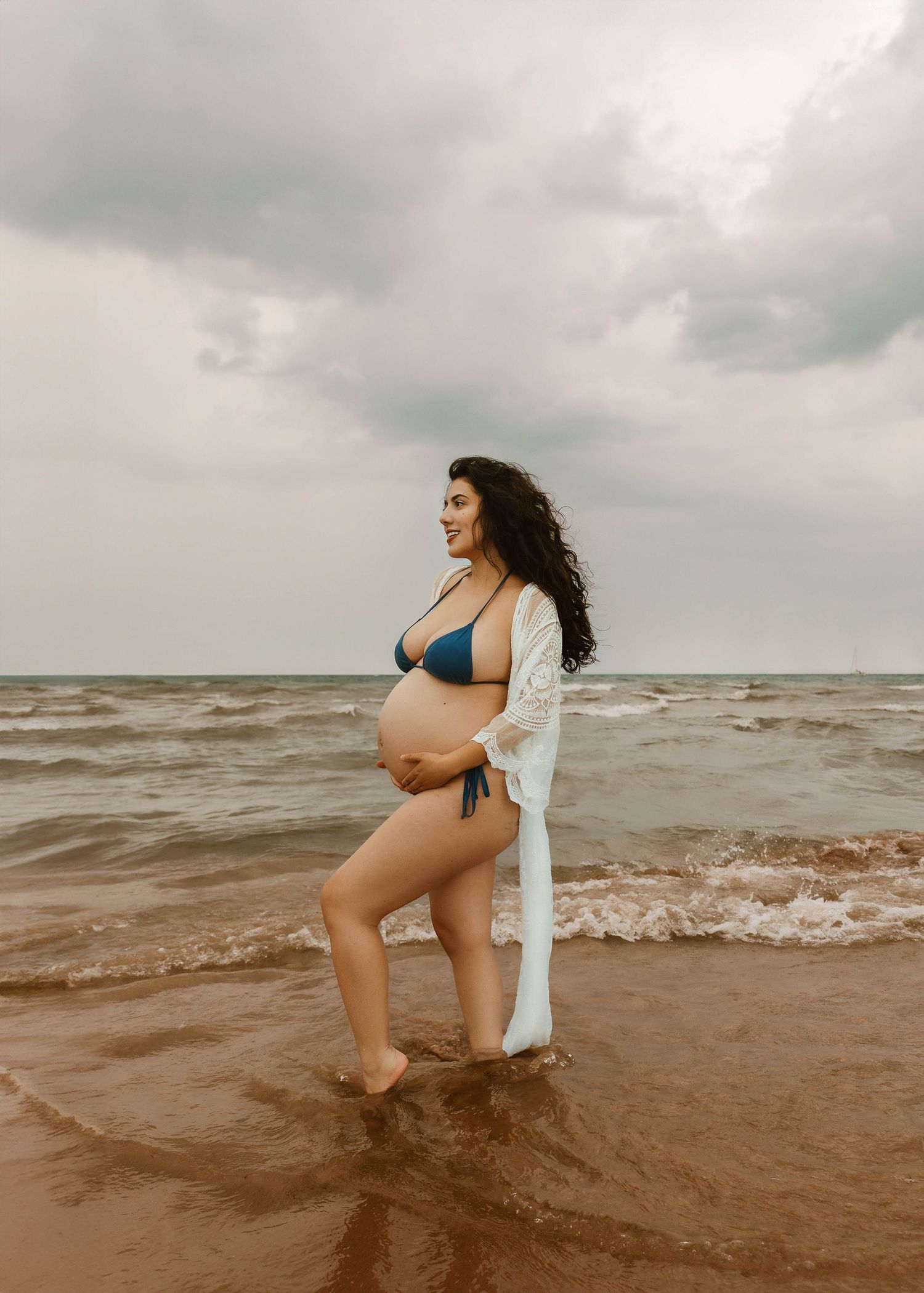 Beach Swim maternity session on overcast day on Montrose Beach in Chicago, IL