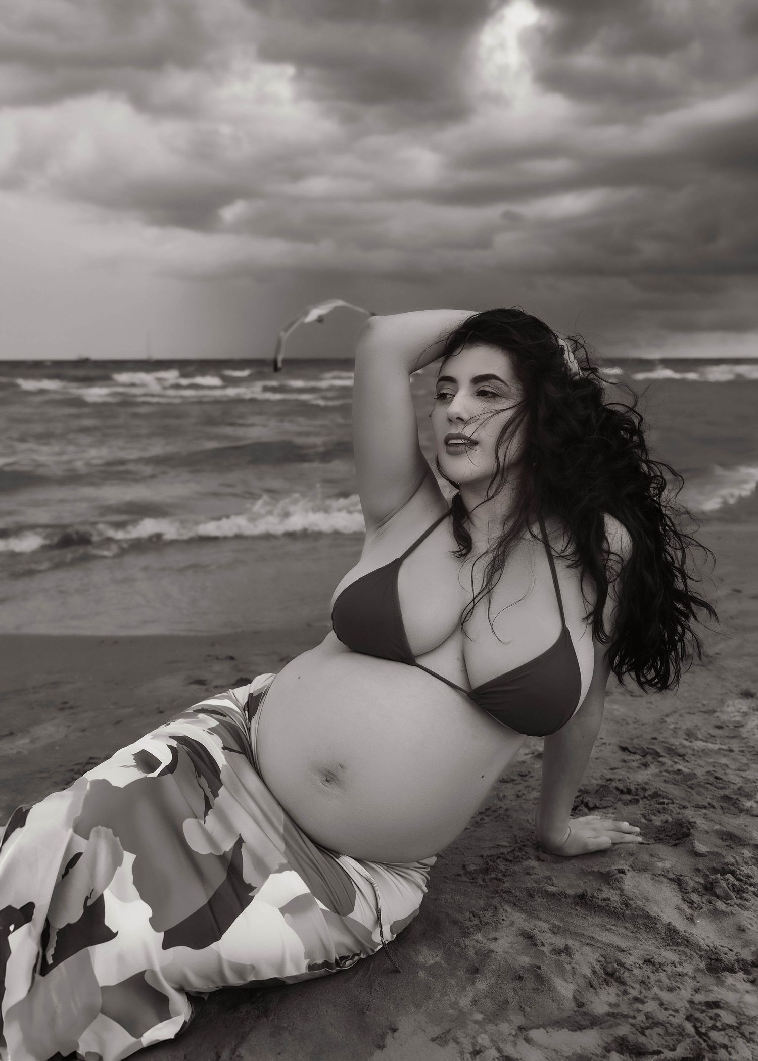 Beach Swim maternity session on overcast day on Montrose Beach in Chicago, IL