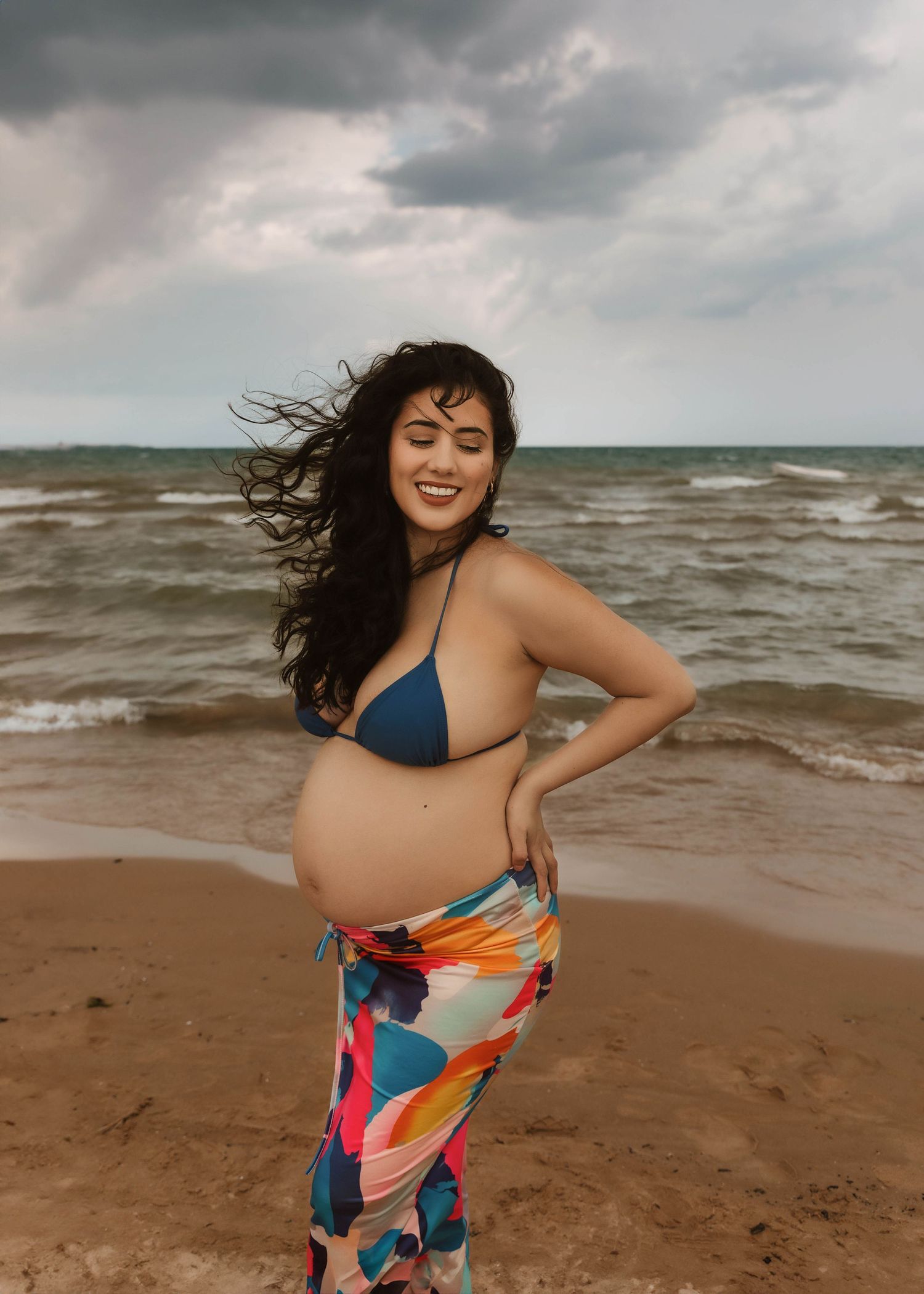 Beach Swim maternity session on overcast day on Montrose Beach in Chicago, IL