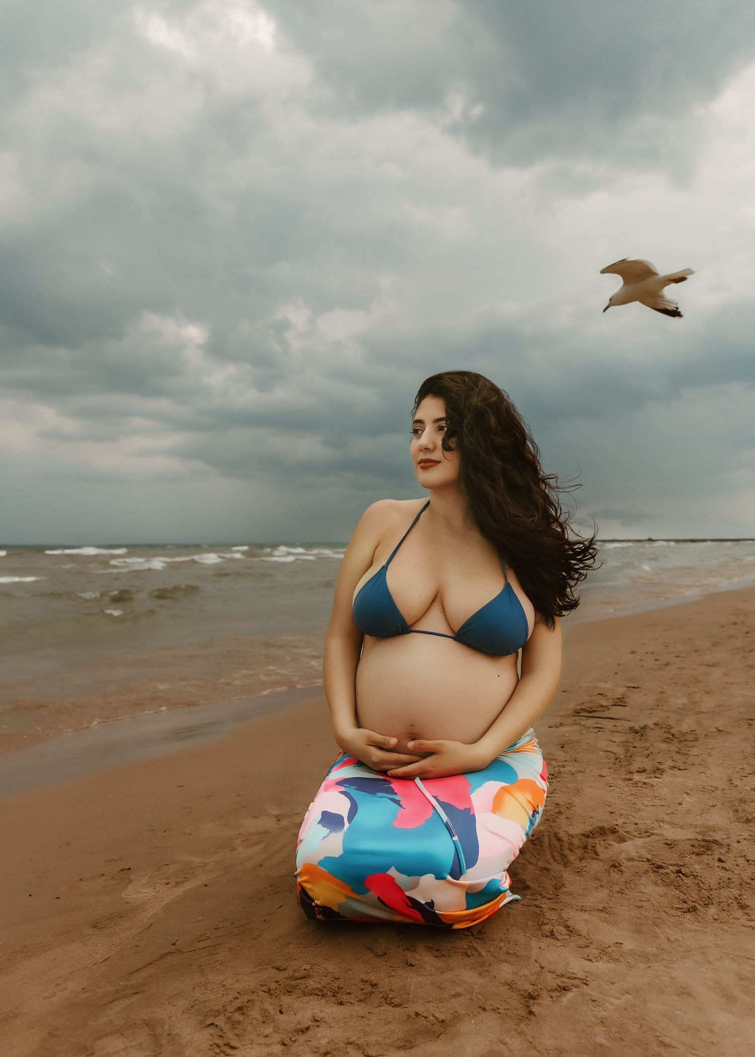 Beach Swim maternity session on overcast day on Montrose Beach in Chicago, IL