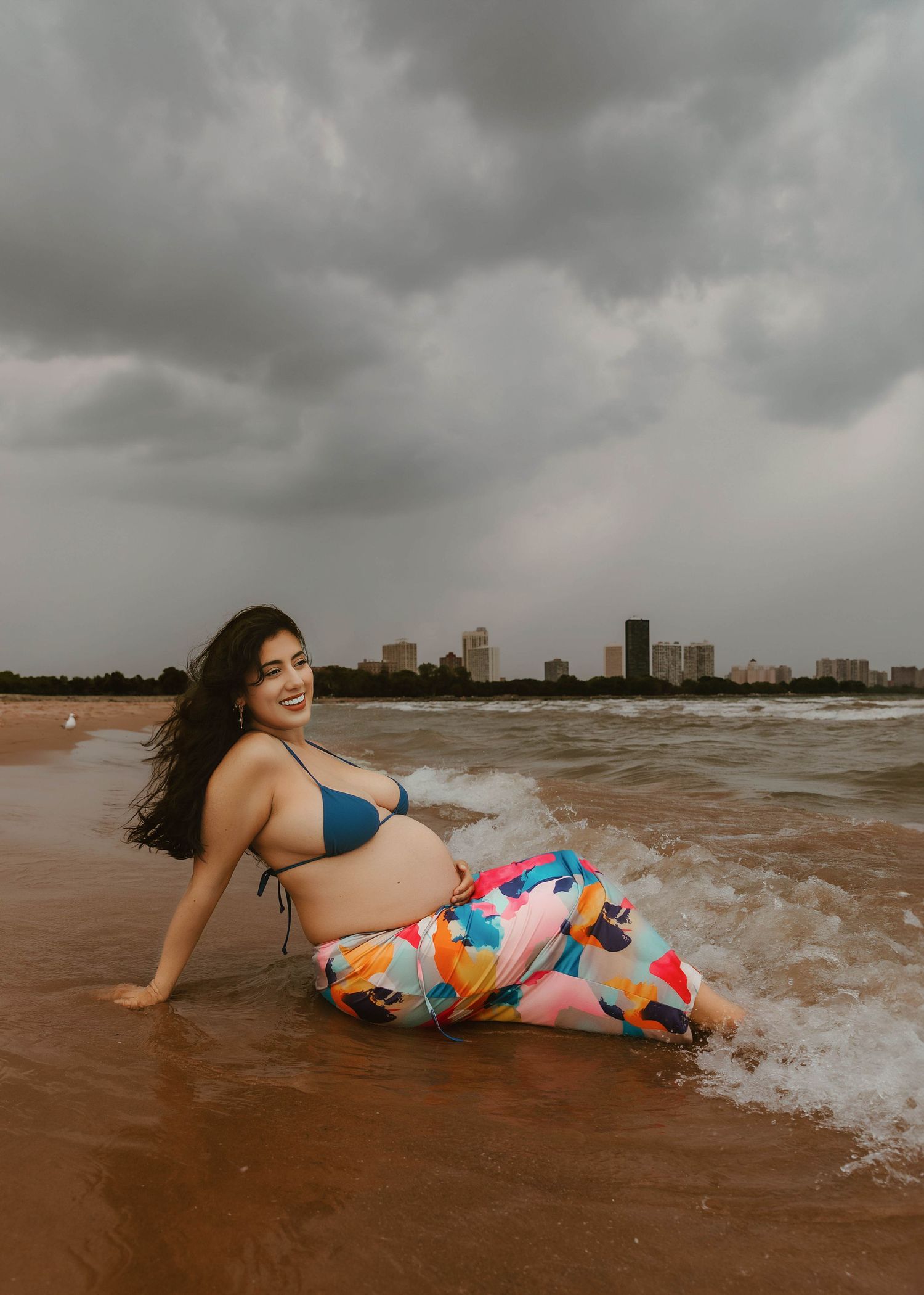 Beach Swim maternity session on overcast day on Montrose Beach in Chicago, IL