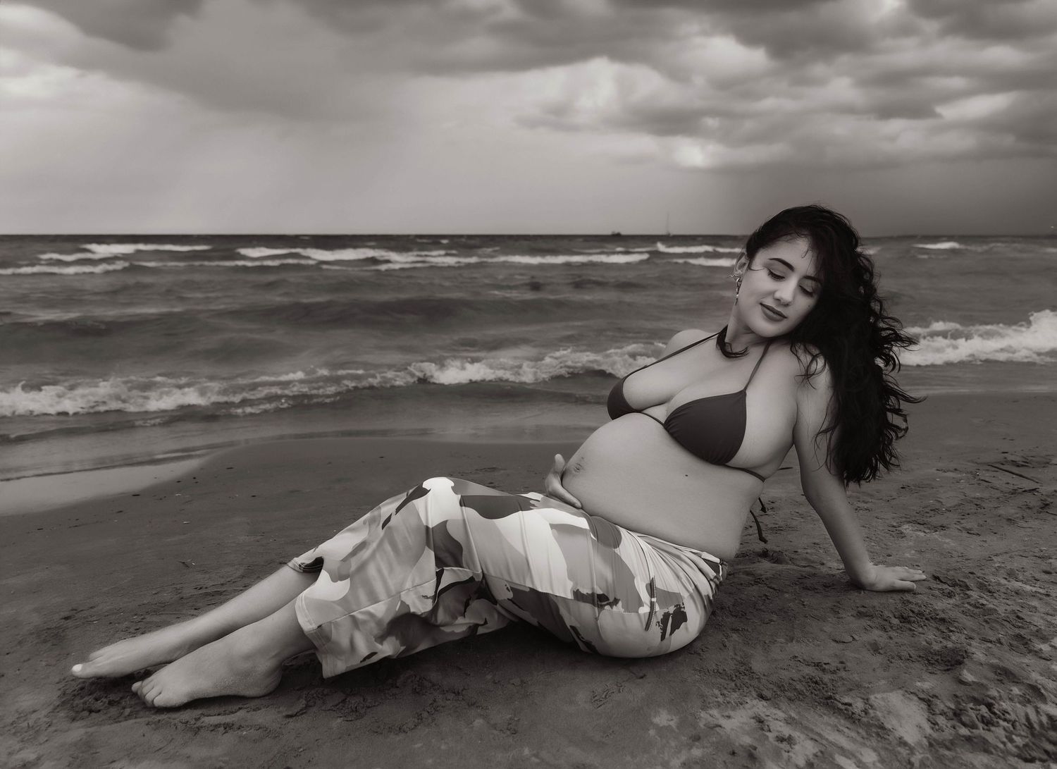 Beach Swim maternity session on overcast day on Montrose Beach in Chicago, IL