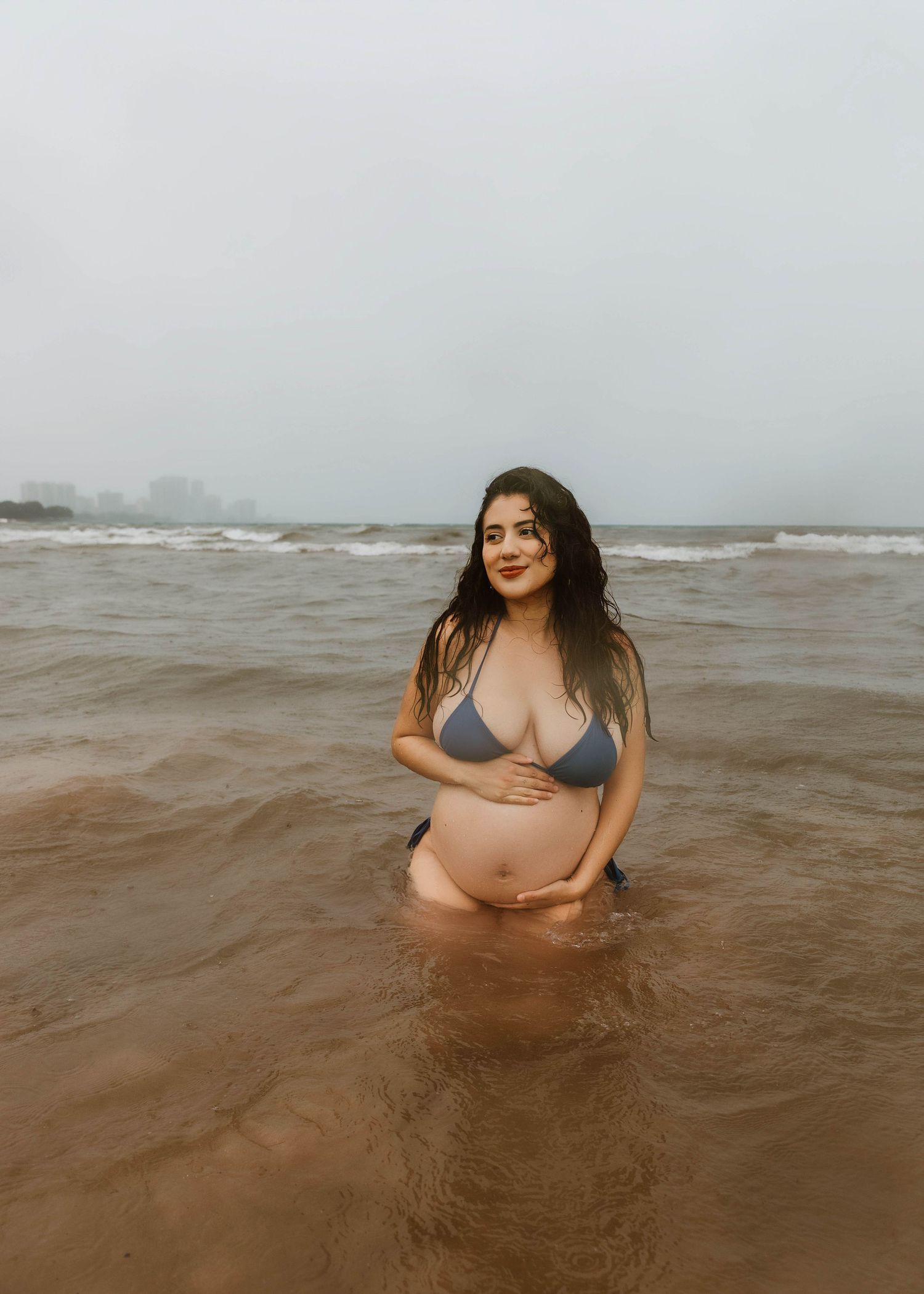 Beach Swim maternity session on overcast day on Montrose Beach in Chicago, IL