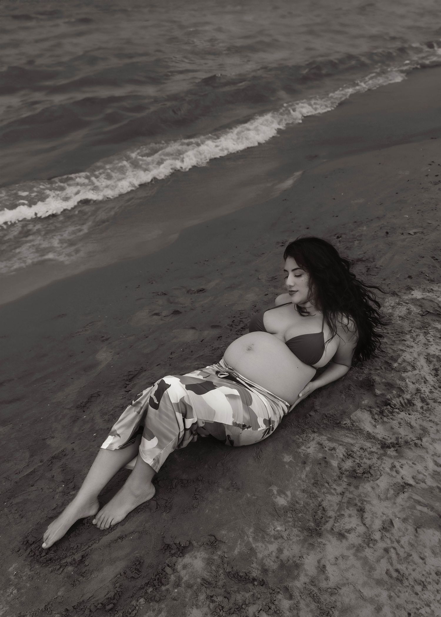 Beach Swim maternity session on overcast day on Montrose Beach in Chicago, IL