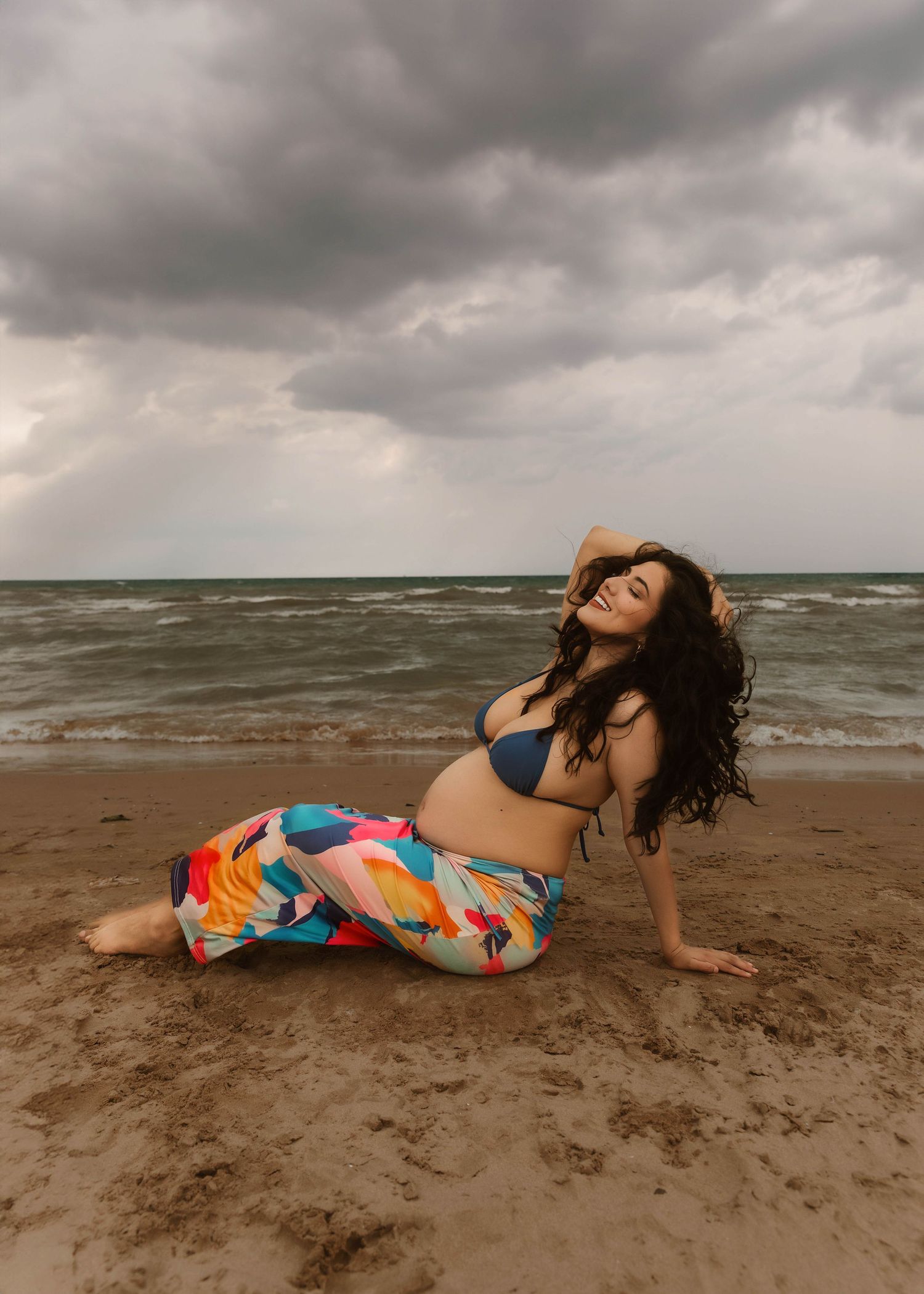 Beach Swim maternity session on overcast day on Montrose Beach in Chicago, IL