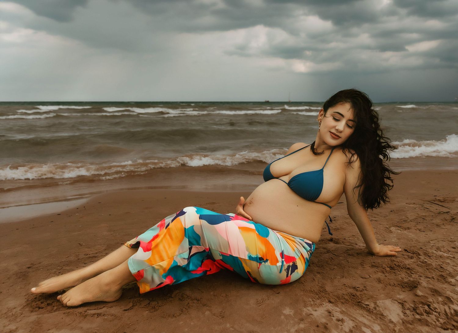 Beach Swim maternity session on overcast day on Montrose Beach in Chicago, IL