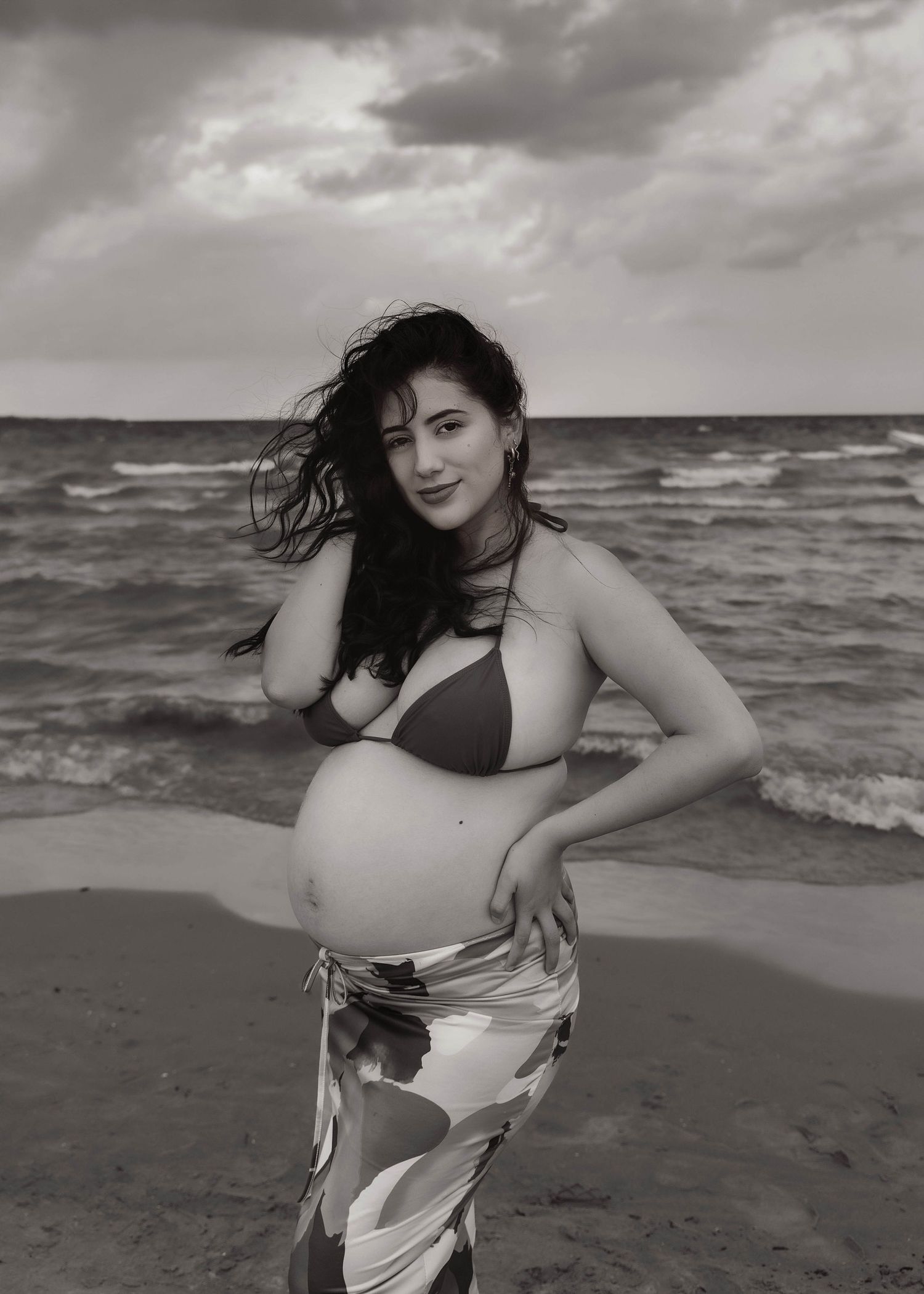 Beach Swim maternity session on overcast day on Montrose Beach in Chicago, IL