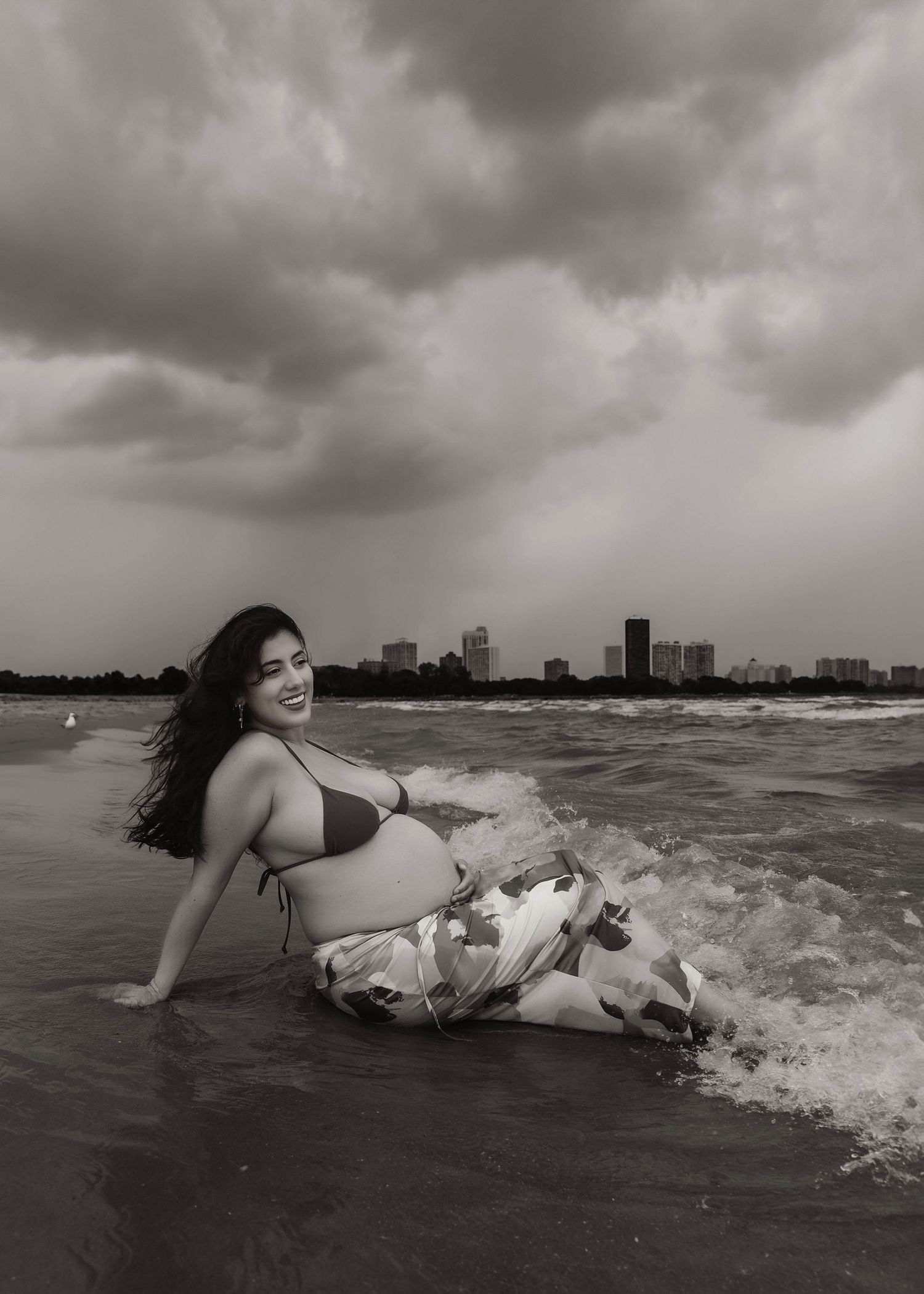 Beach Swim maternity session on overcast day on Montrose Beach in Chicago, IL
