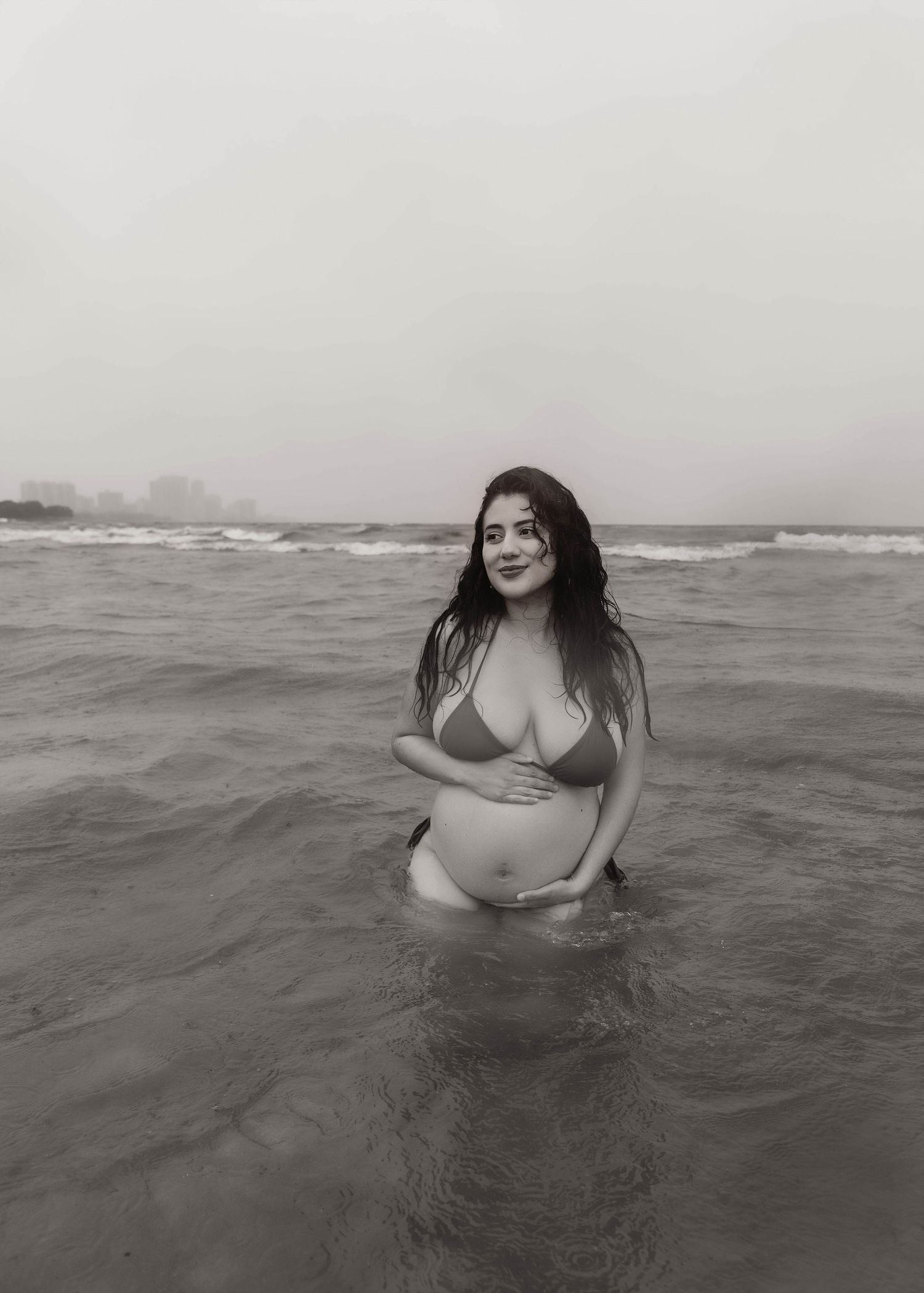 Beach Swim maternity session on overcast day on Montrose Beach in Chicago, IL