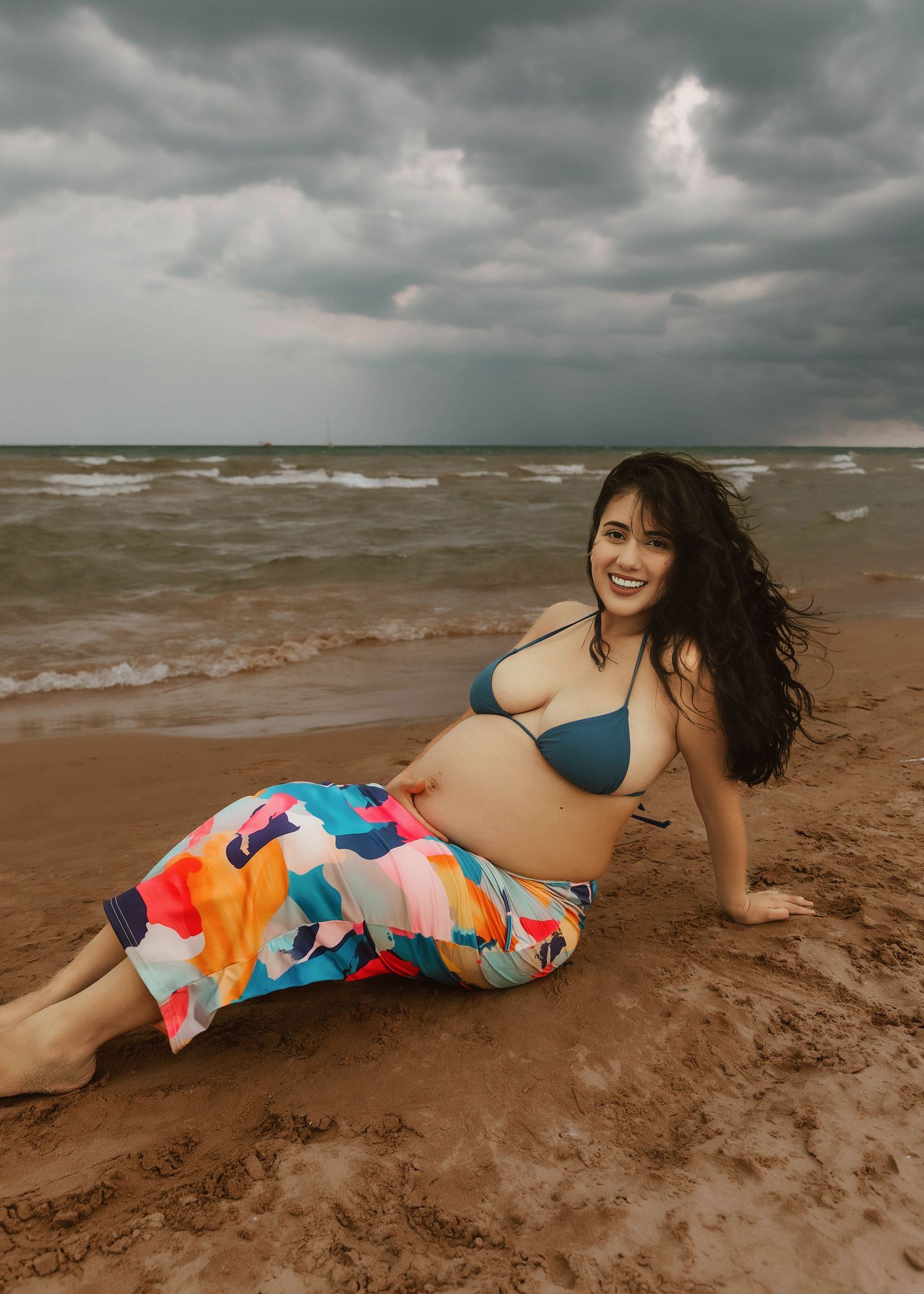 Beach Swim maternity session on overcast day on Montrose Beach in Chicago, IL