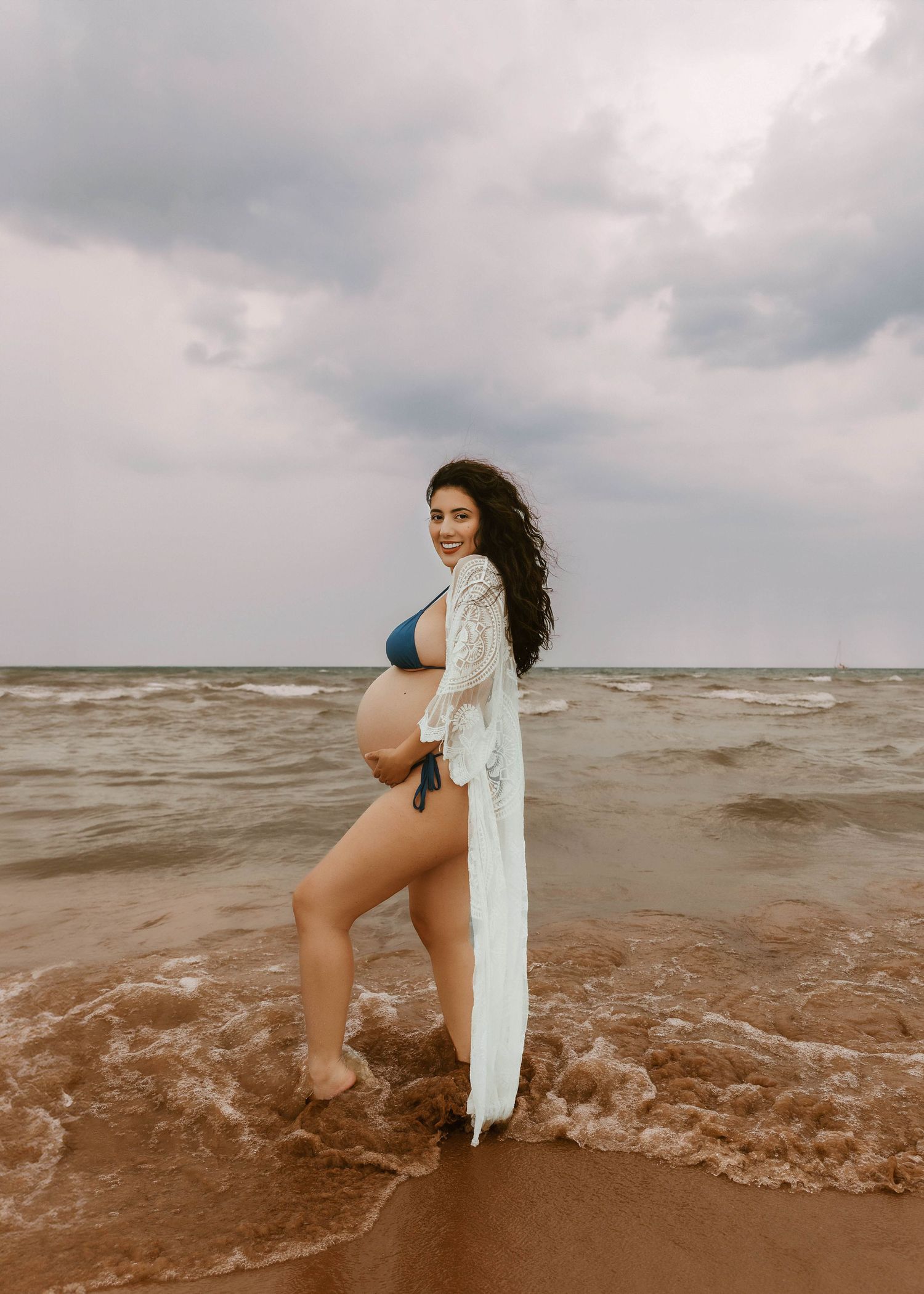Beach Swim maternity session on overcast day on Montrose Beach in Chicago, IL