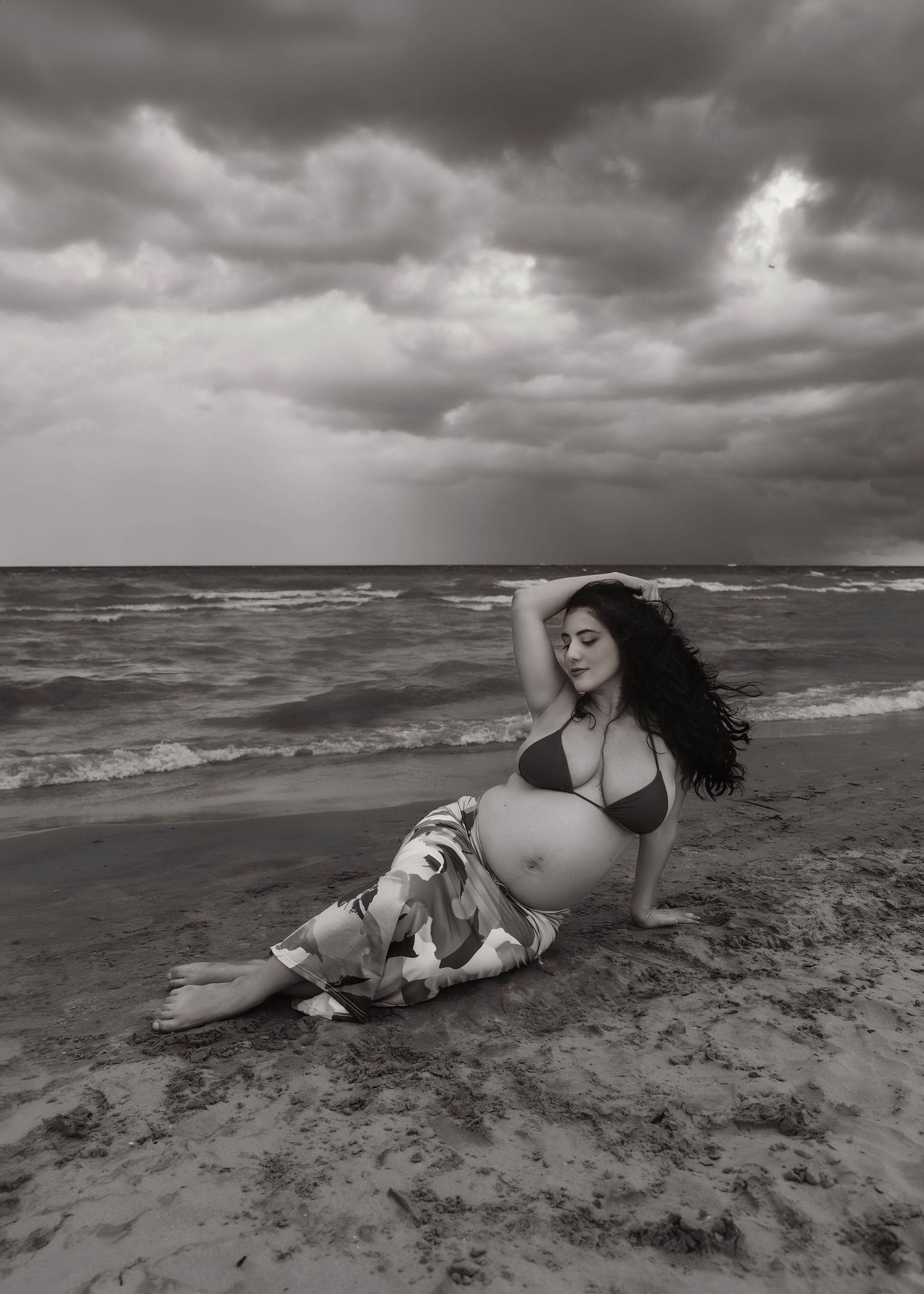 Beach Swim maternity session on overcast day on Montrose Beach in Chicago, IL