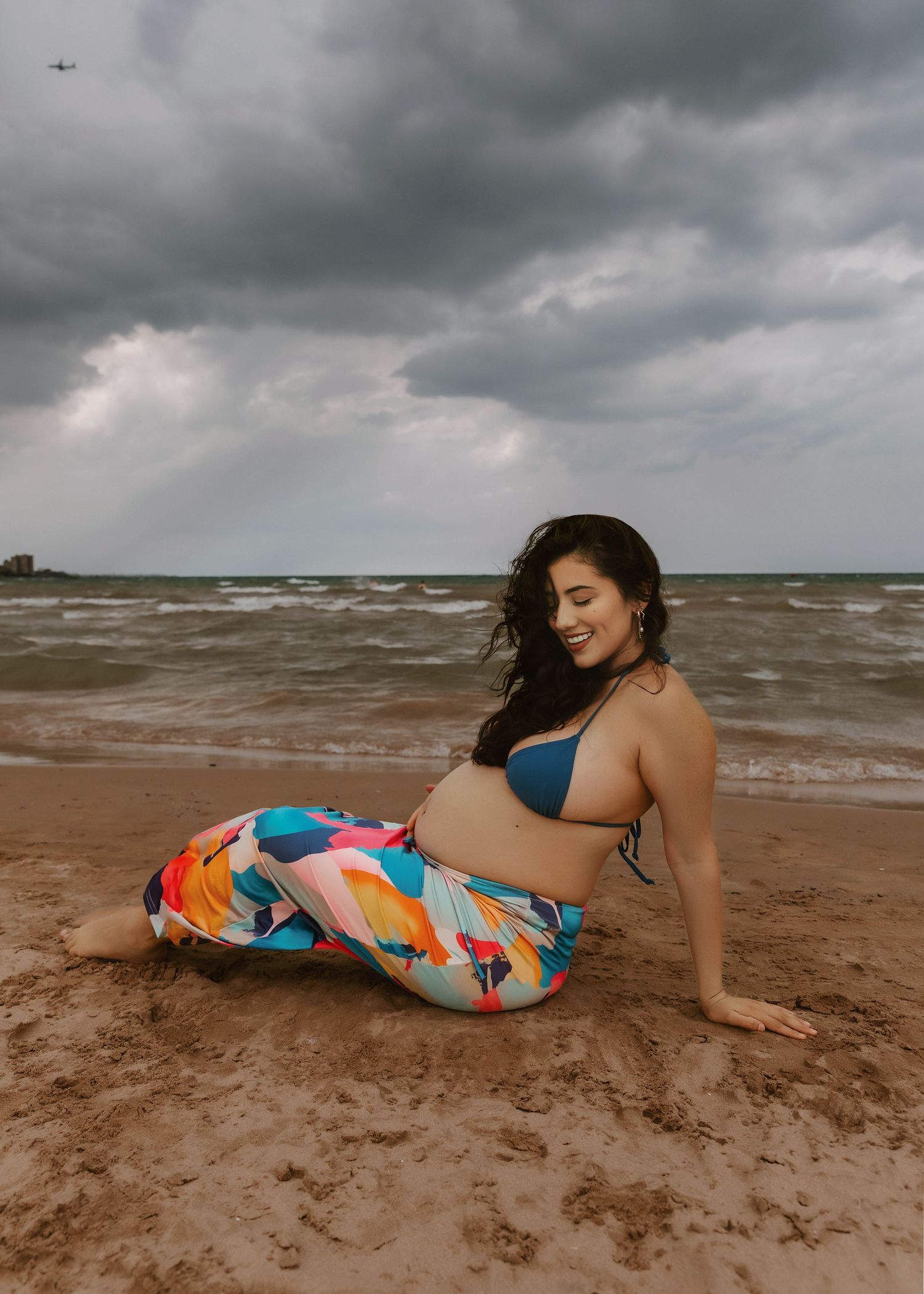 Beach Swim maternity session on overcast day on Montrose Beach in Chicago, IL