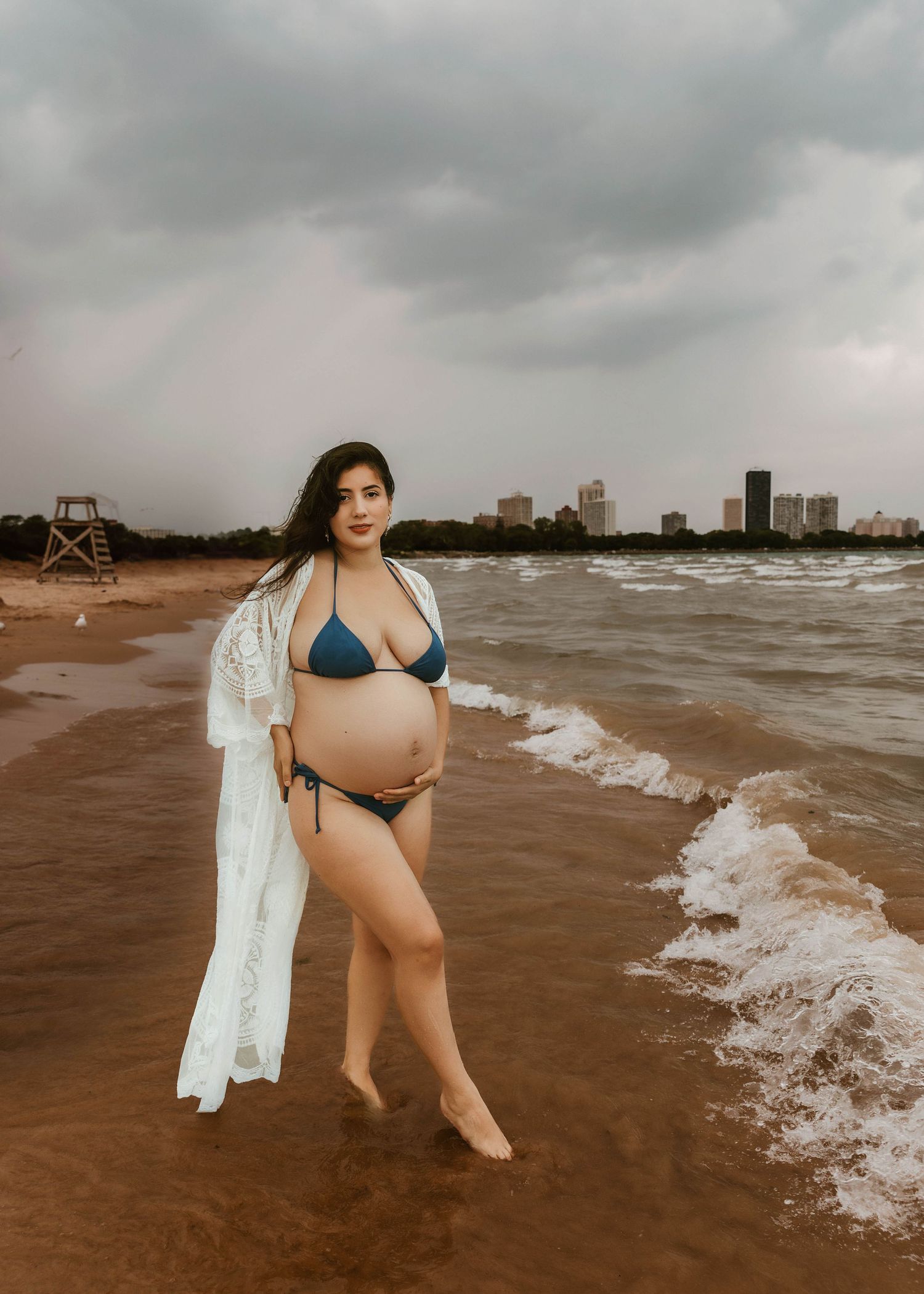 Beach Swim maternity session on overcast day on Montrose Beach in Chicago, IL