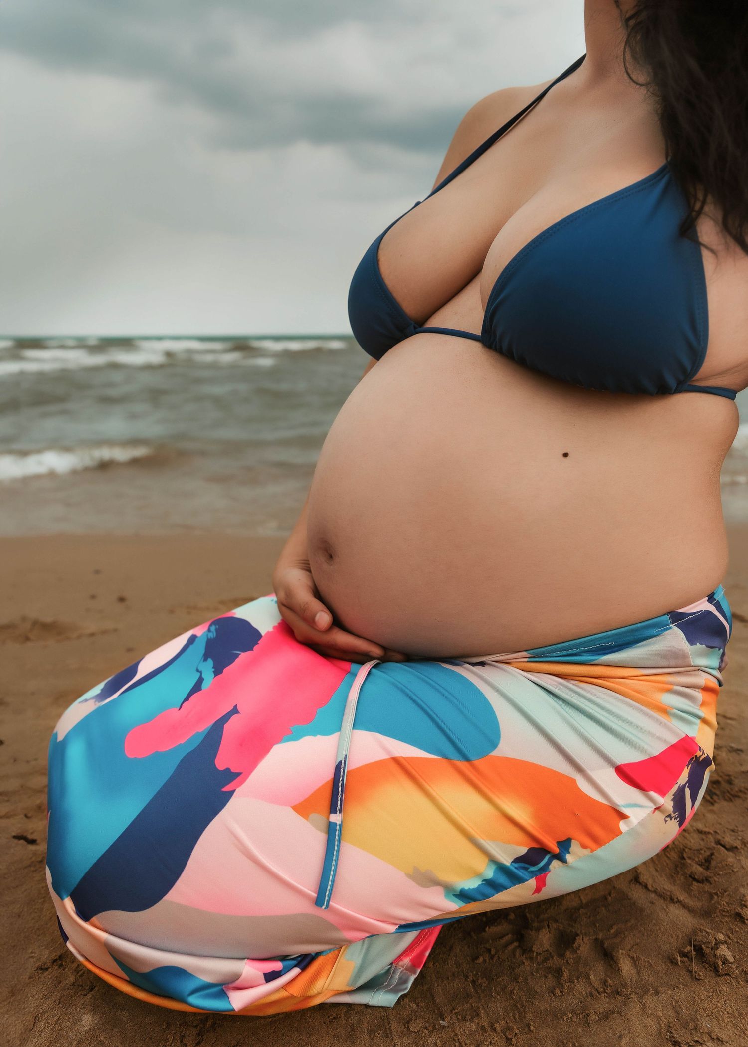 Beach Swim maternity session on overcast day on Montrose Beach in Chicago, IL