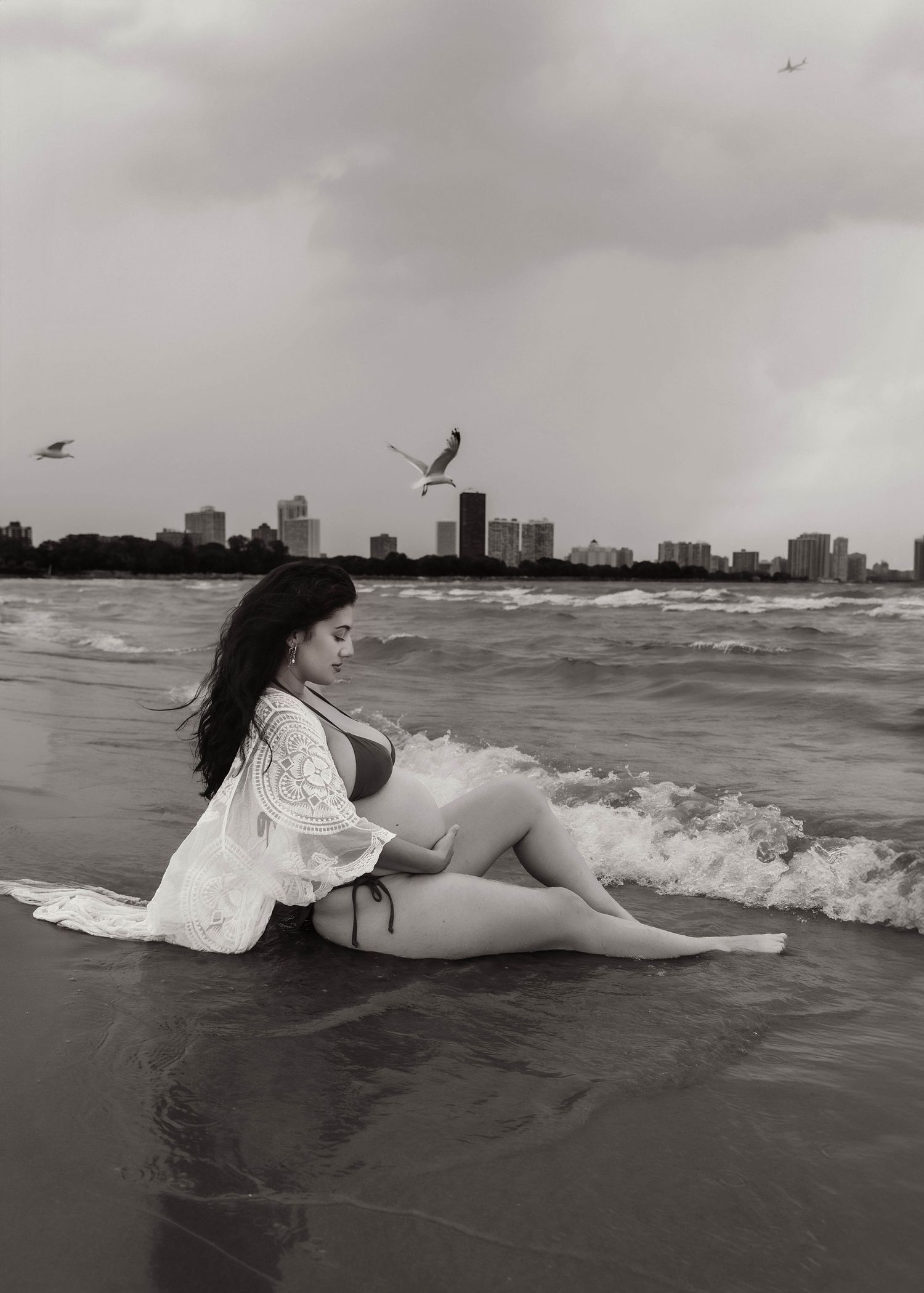 Beach Swim maternity session on overcast day on Montrose Beach in Chicago, IL
