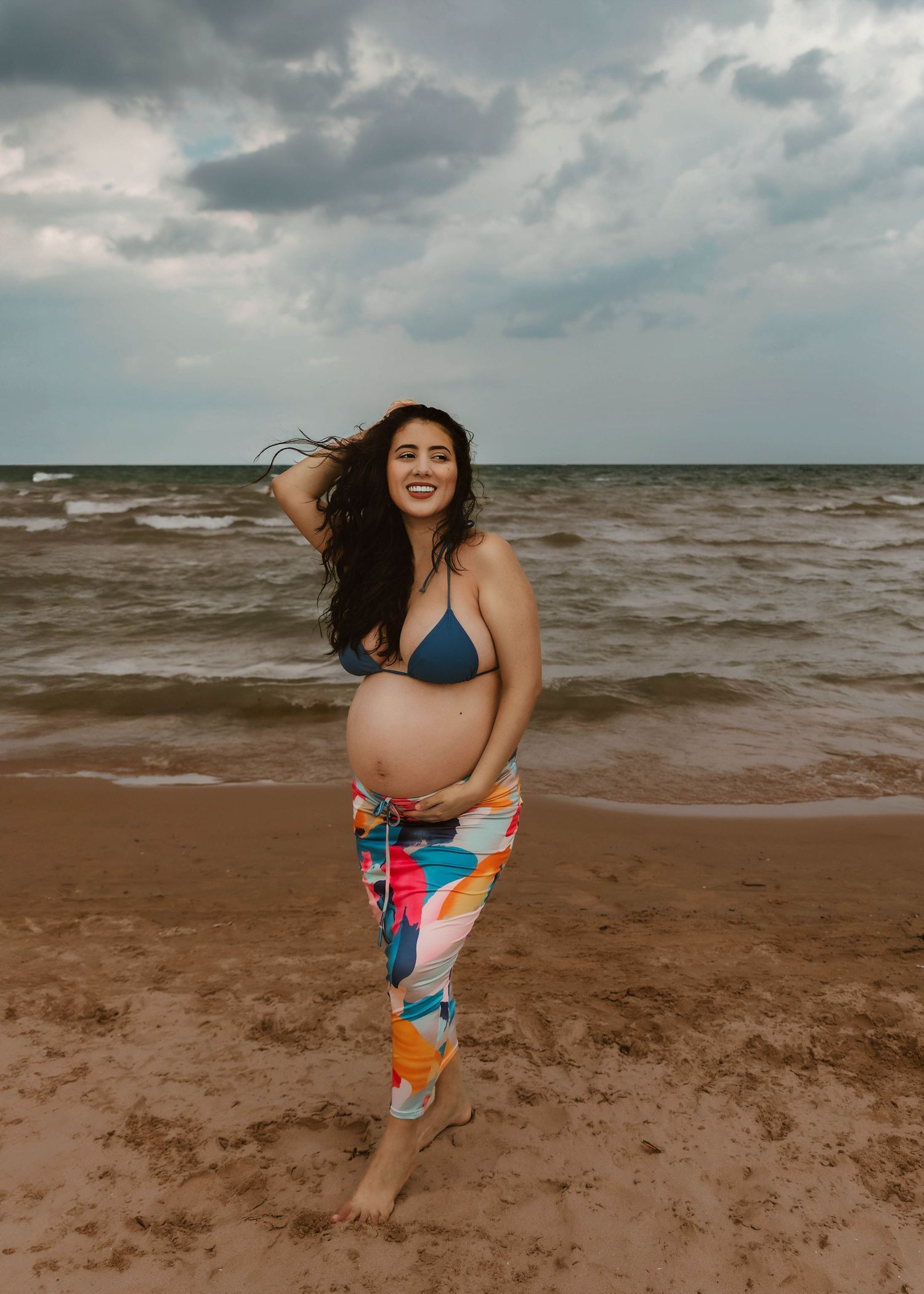 Beach Swim maternity session on overcast day on Montrose Beach in Chicago, IL