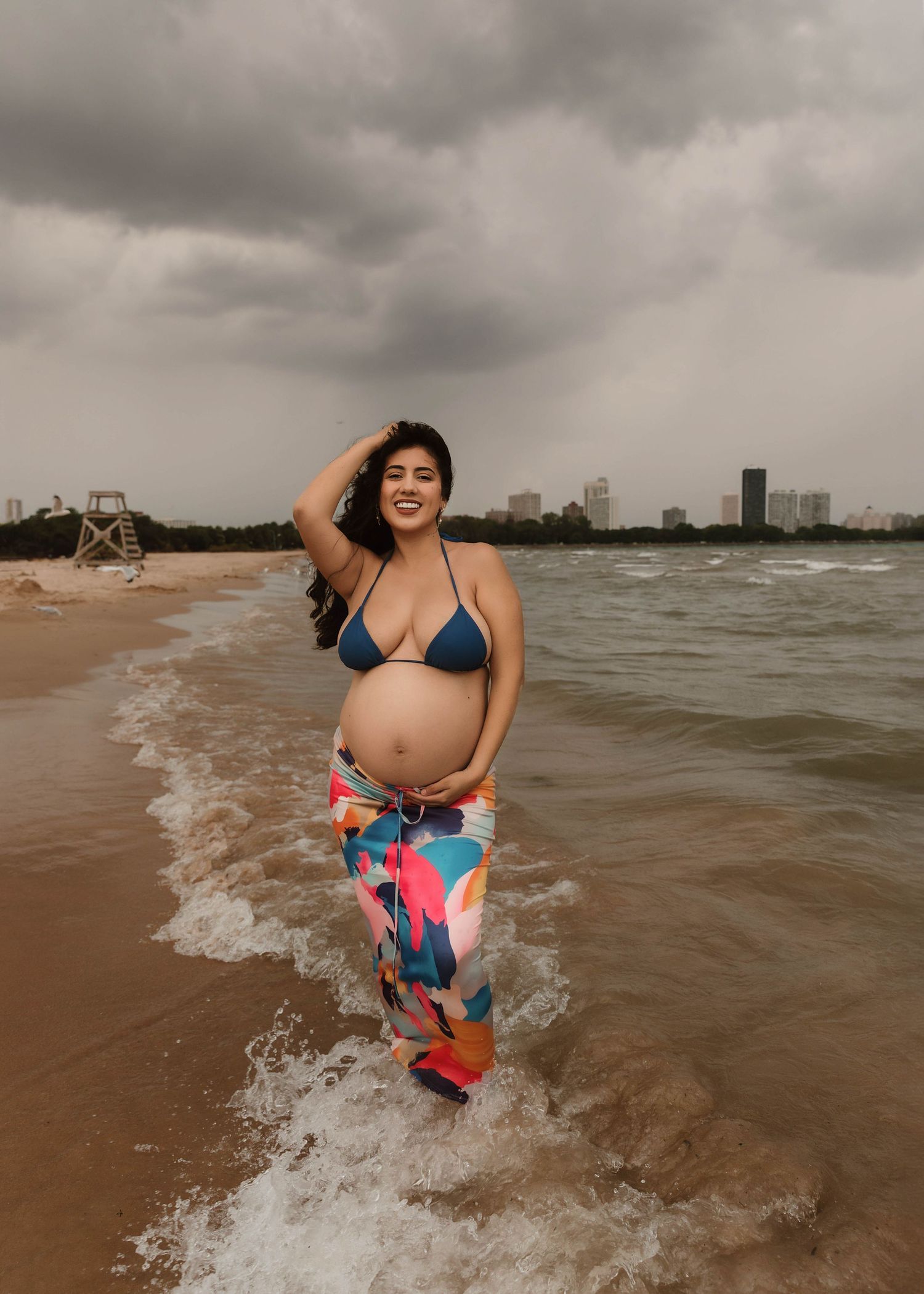 Beach Swim maternity session on overcast day on Montrose Beach in Chicago, IL