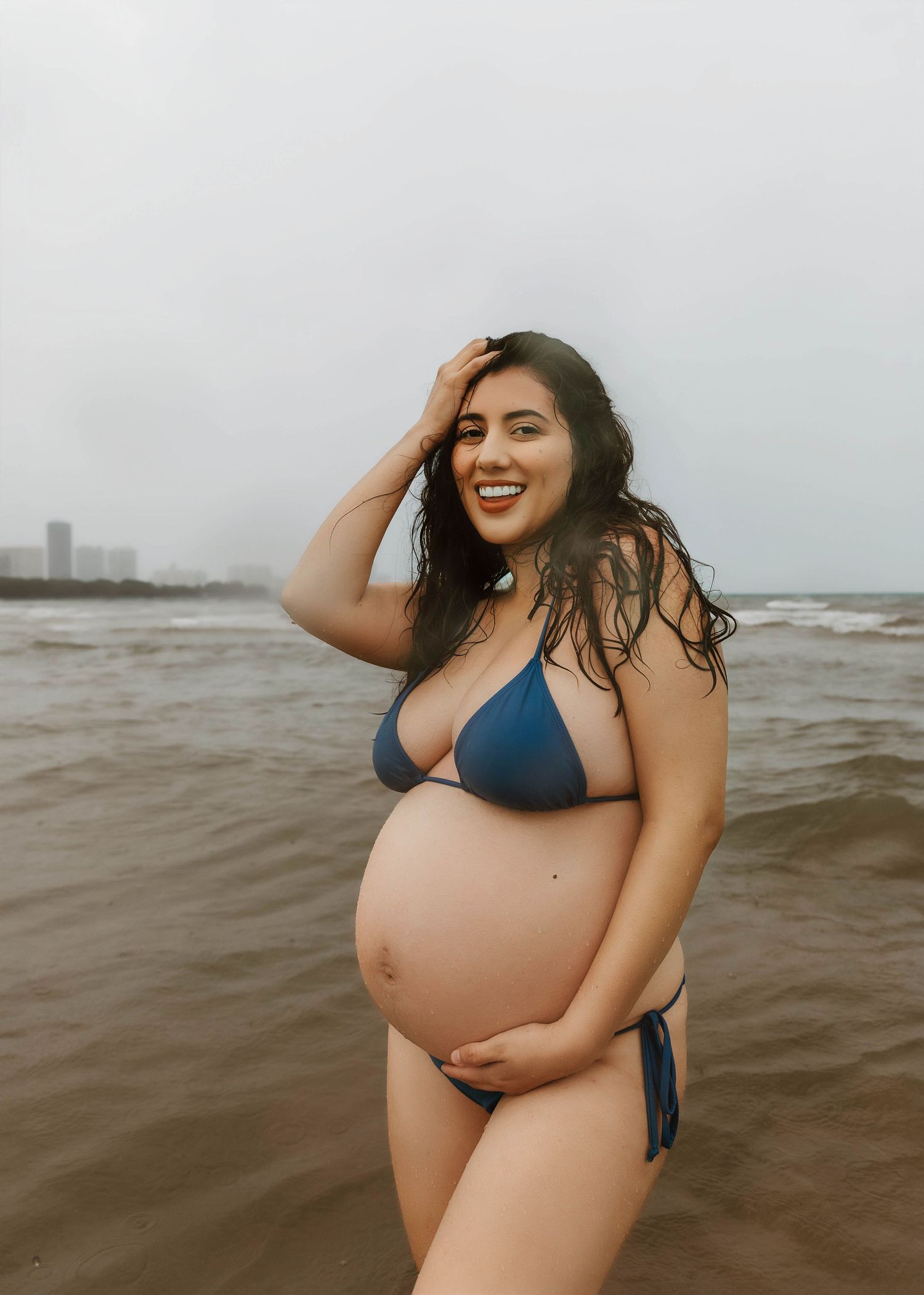 Beach Swim maternity session on overcast day on Montrose Beach in Chicago, IL