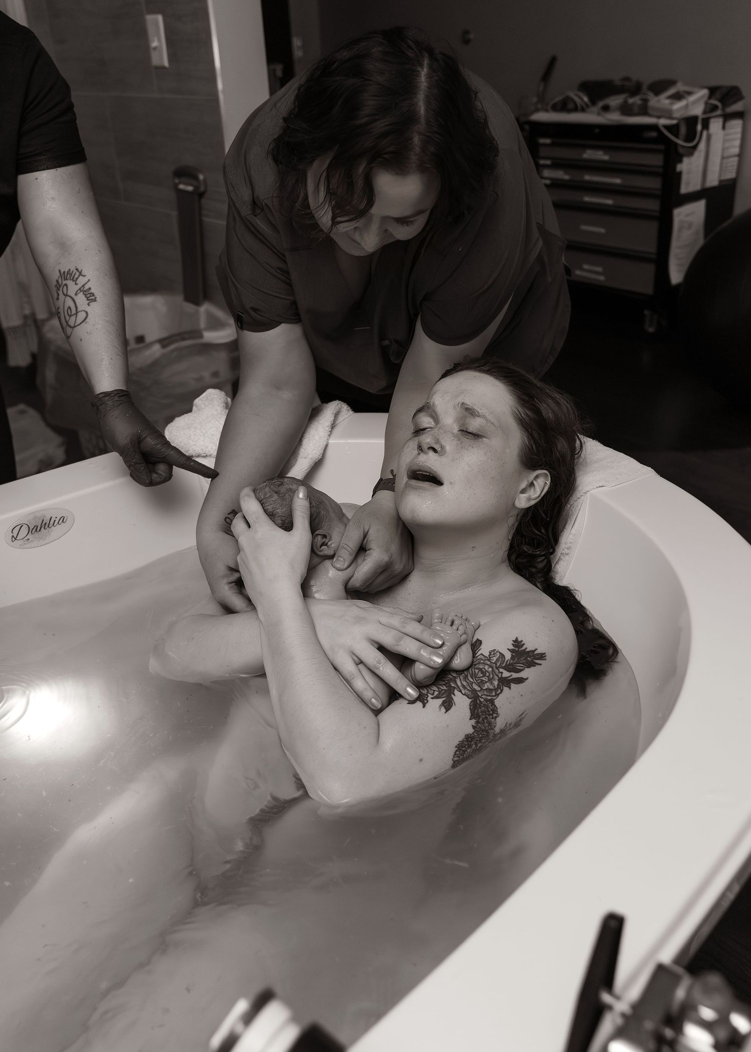 The moment you get to hold your baby for the first time. Birth Photography in tub in Bloomington, IL